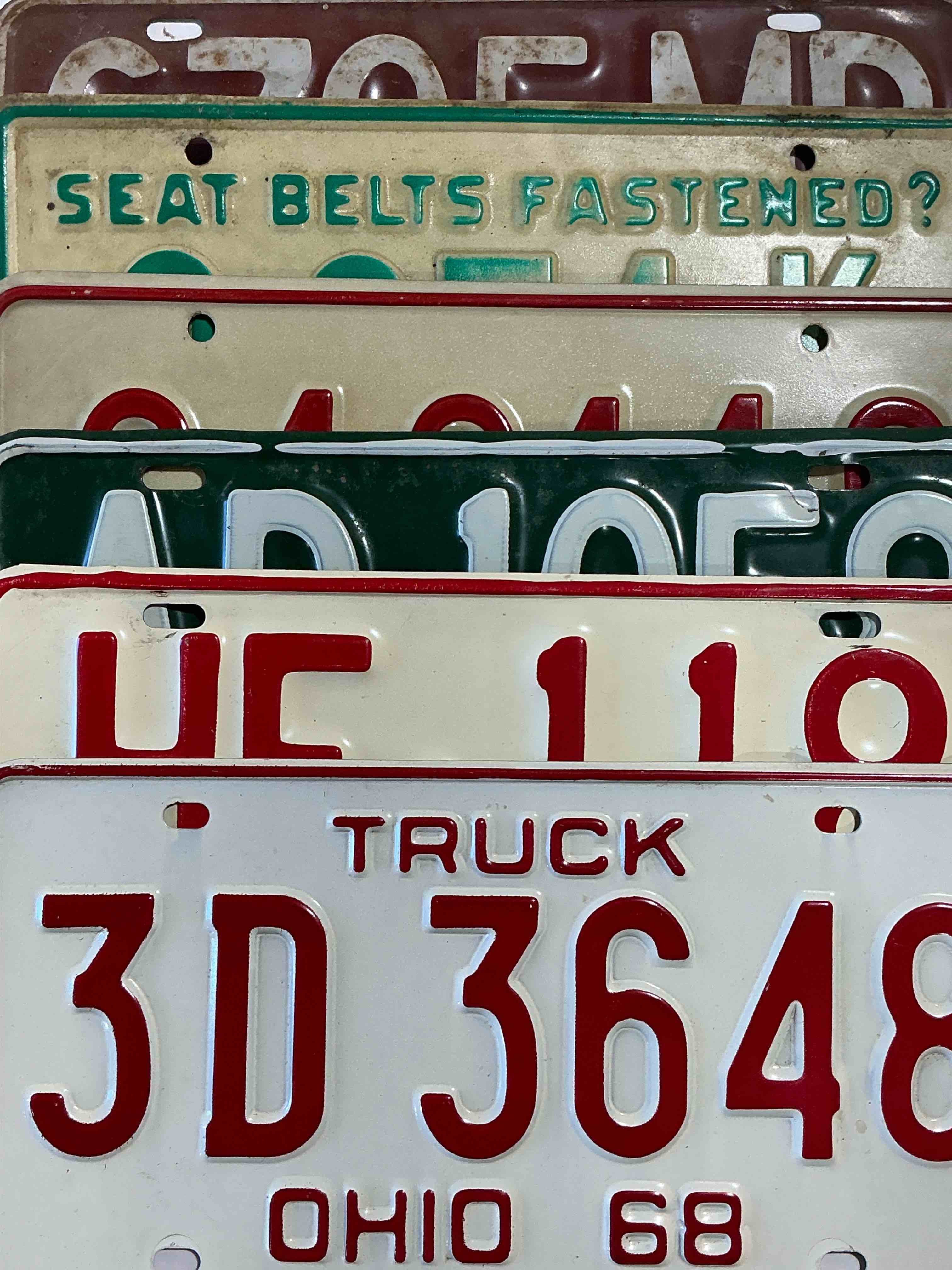 license plate history, wow!  authentic, original ohio license plates spanning multiple decades!  these are genuine heavy metal time pieces, not replicas!  some rust & barn dust included!  almost impossible to find!  