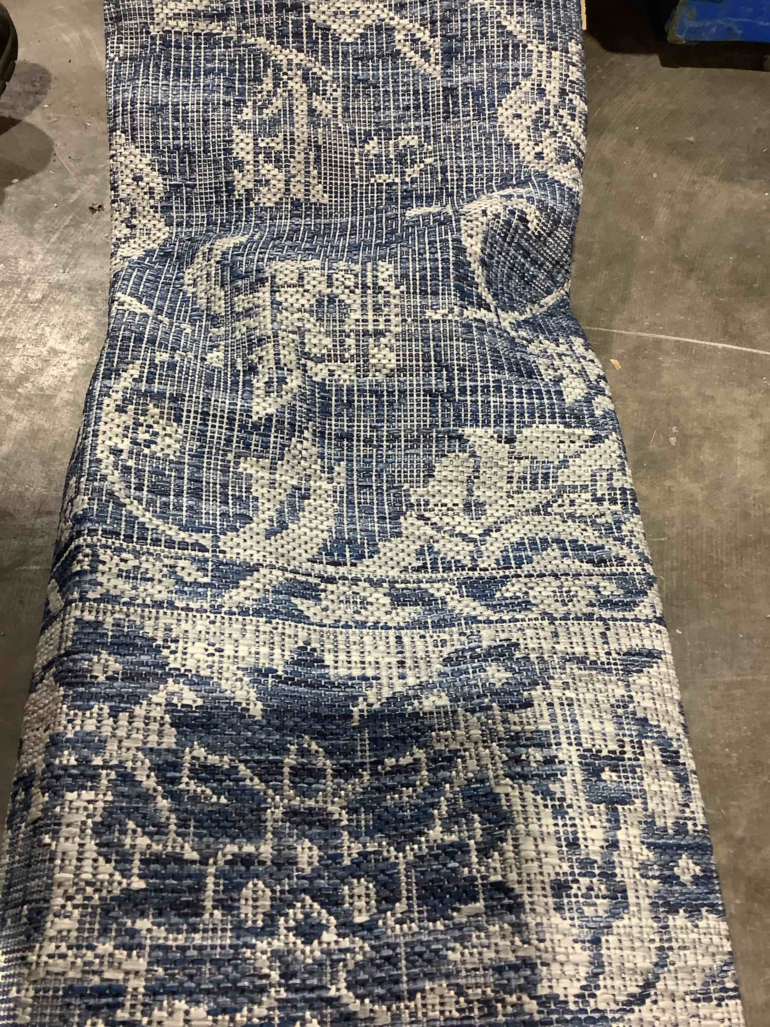 Decorative indoor blue and white rug approximately 6' x 10'