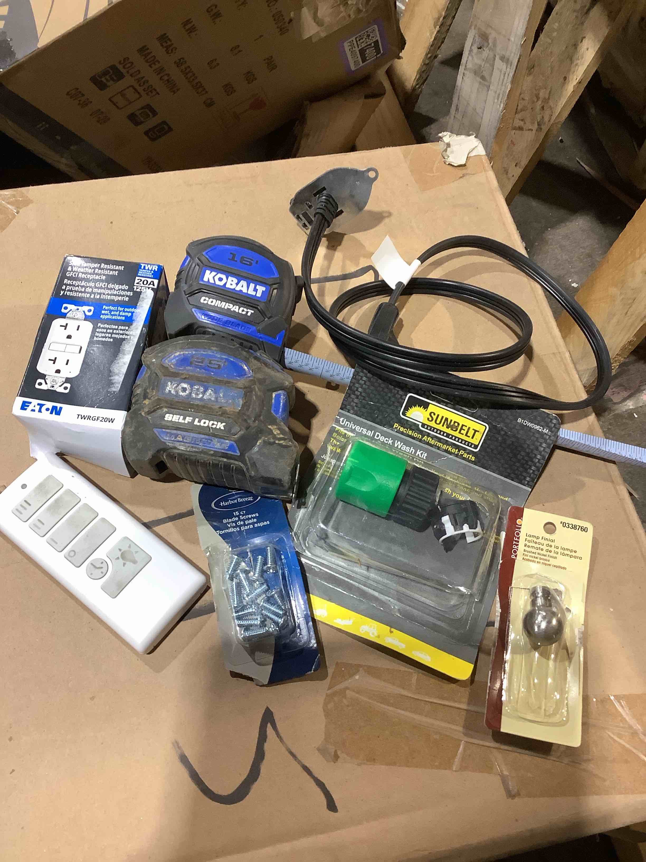 Assortment of household repair items: electric receptor, Kolbalt measuring tape, deck wash kit, lamp end, blade screws, and more