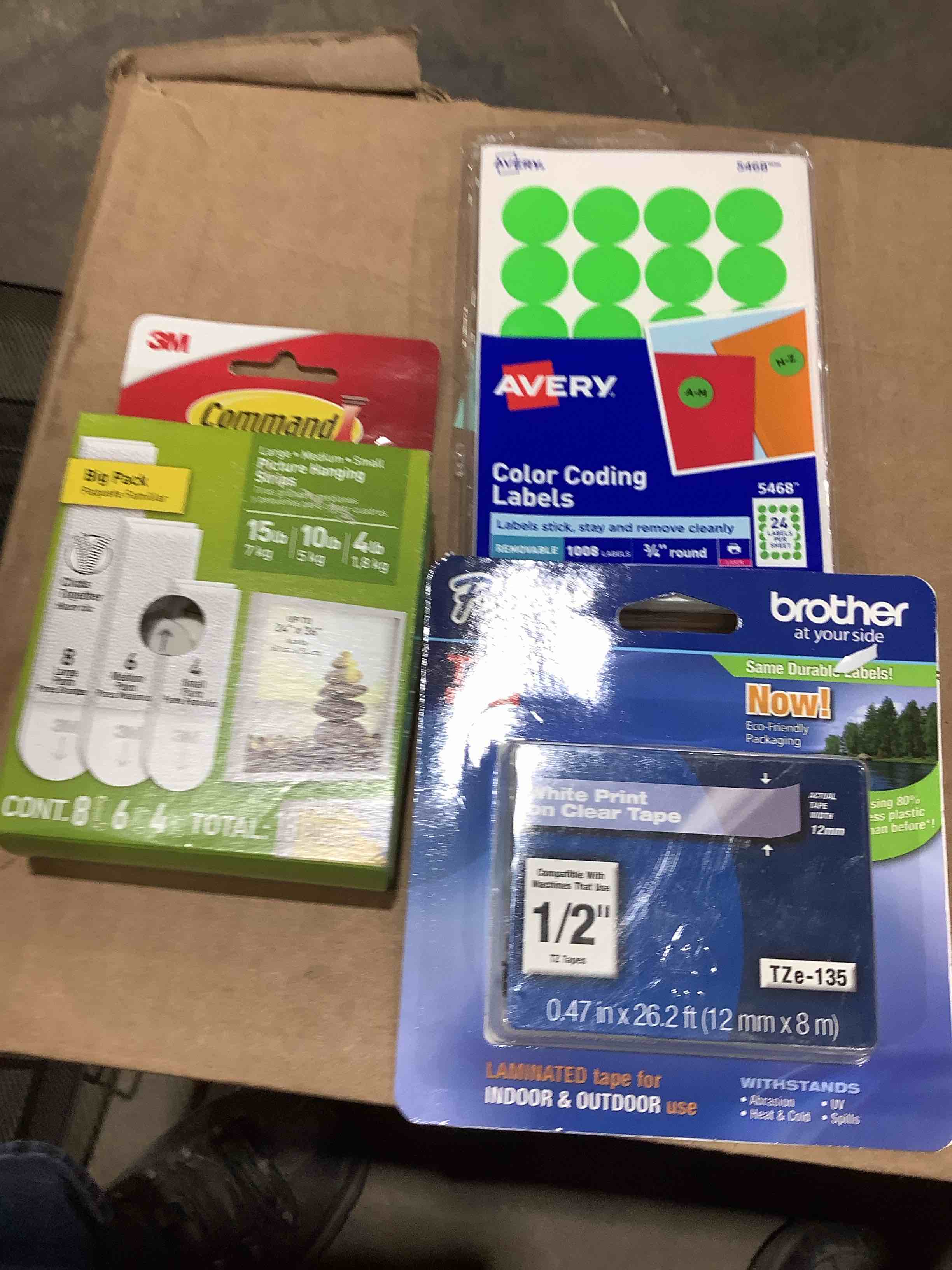 Assorted office supplies: brother half inch TZ tapes, every color, coating labels, 3M command, picture hanging strips