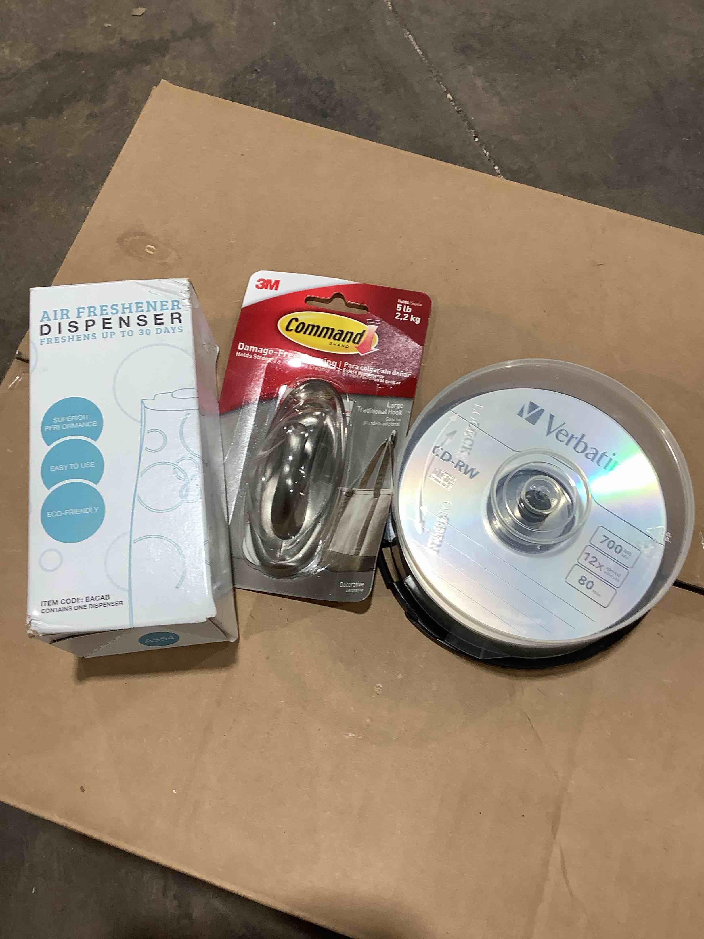 Assortment of office supplies and household goods: air, freshener dispenser, verbatim CD – RW disc, command damage free hanging