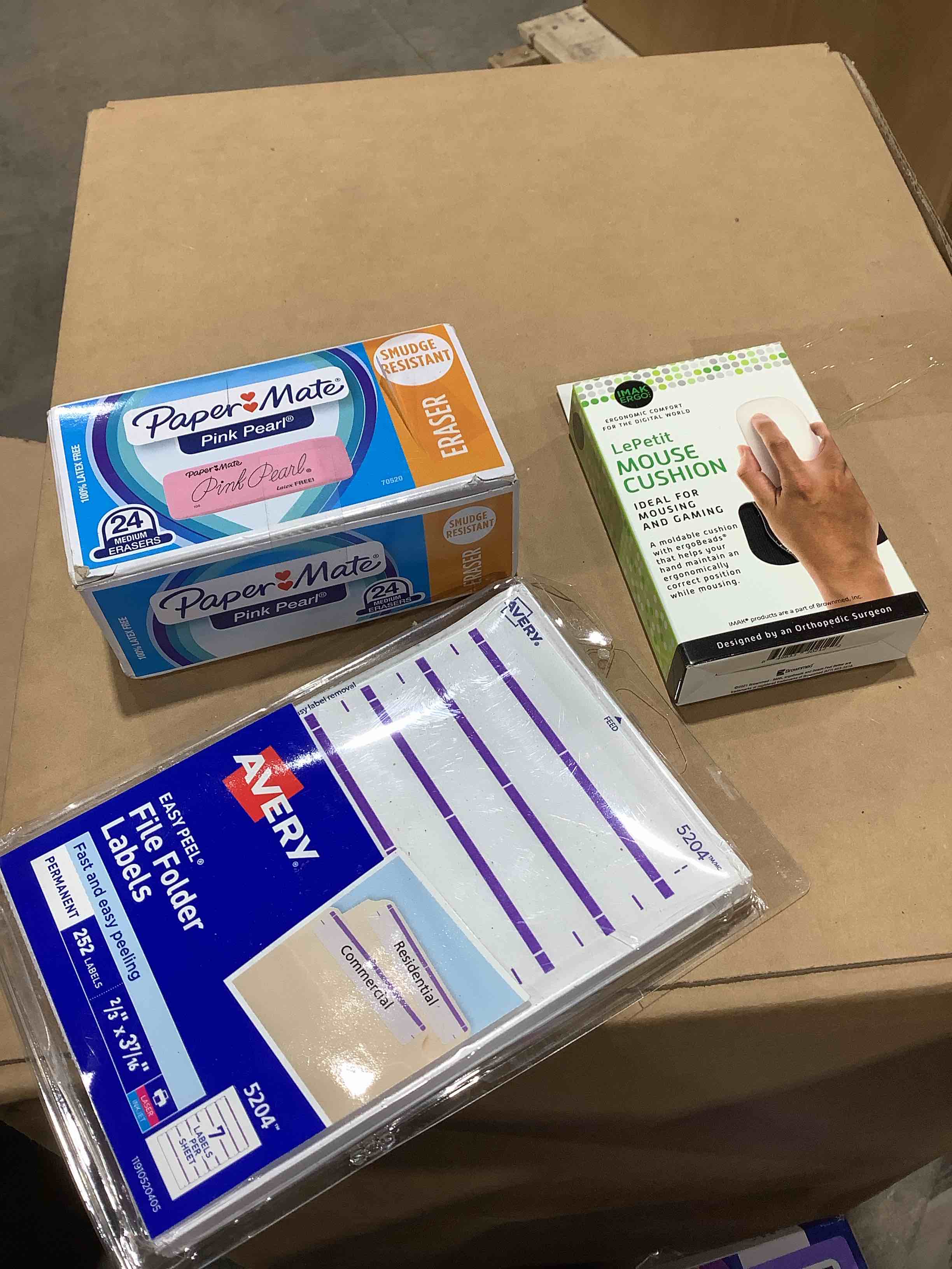 Assorted office supplies: Avery file folder labels, mouse, cushion, papermate pink erasers