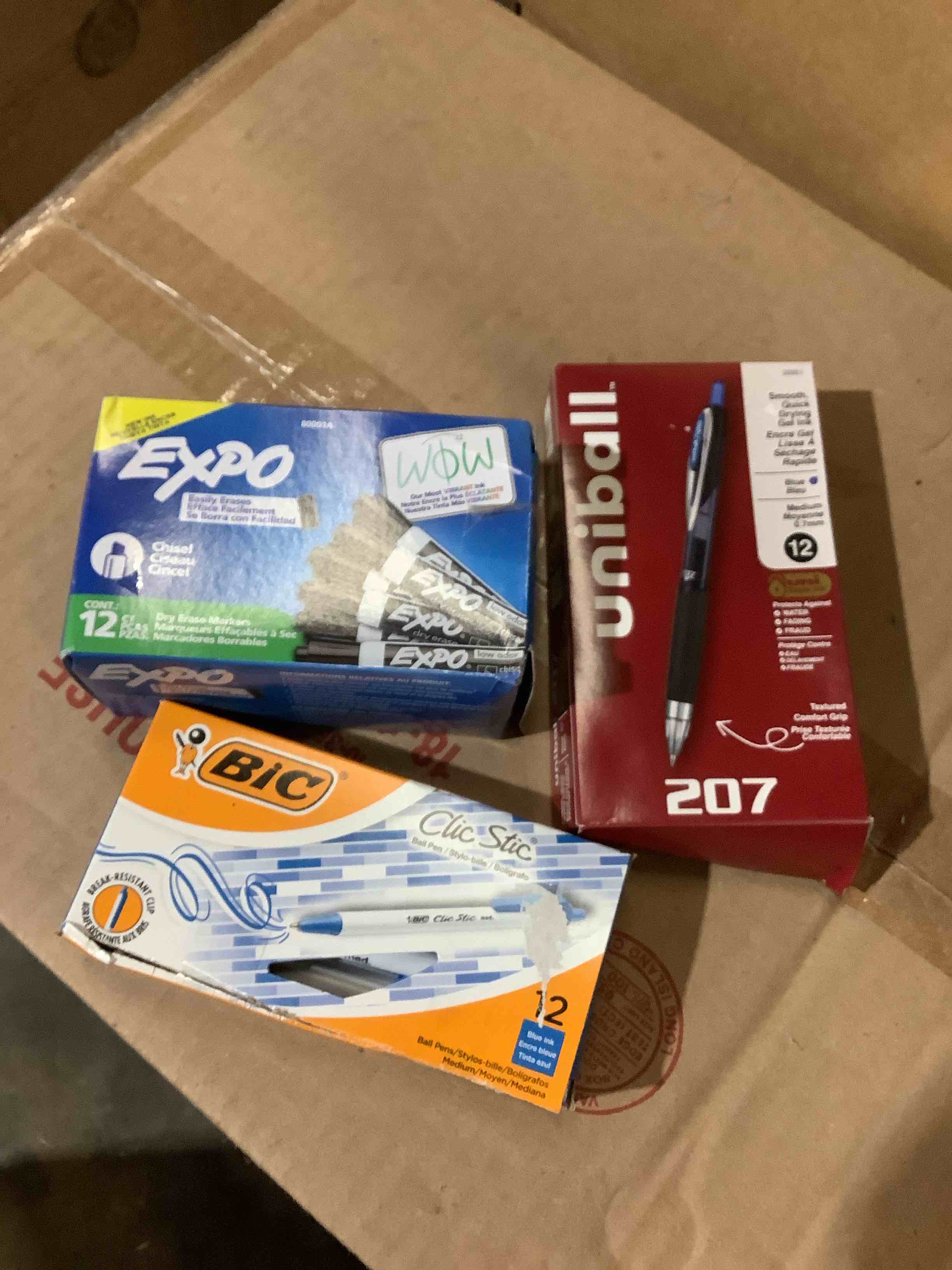 Assorted office supplies: expo dry eraser, pick pens, Uni ball pens
