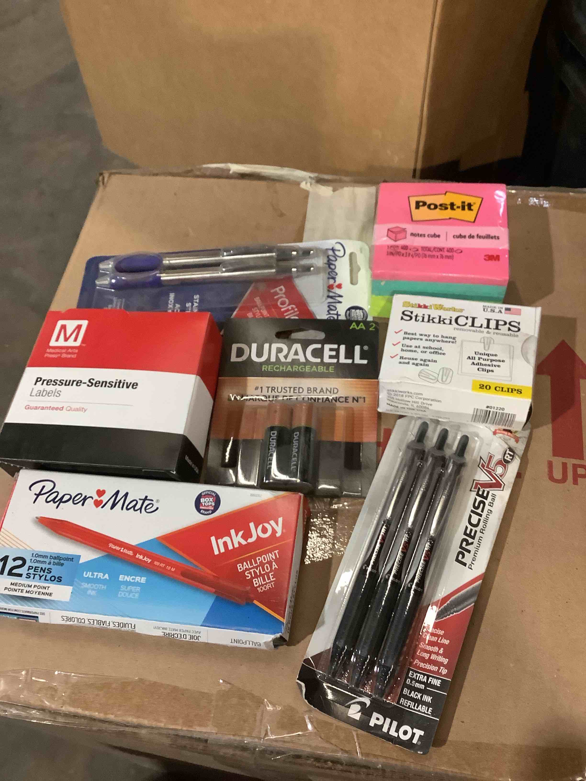 Assorted office supplies; Dura cell batteries, Post-it notes, pilot pens, paper ate, labels and more