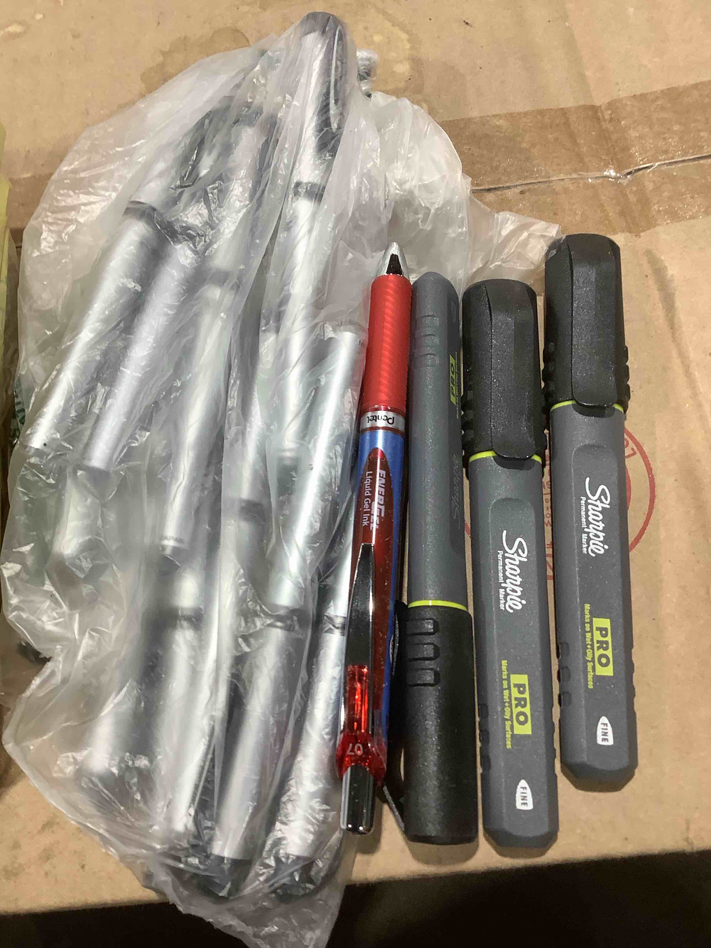 Condition photo showing Good Condition for An assortment of office supplies: post it notepads, sharpie, pro markers, pens