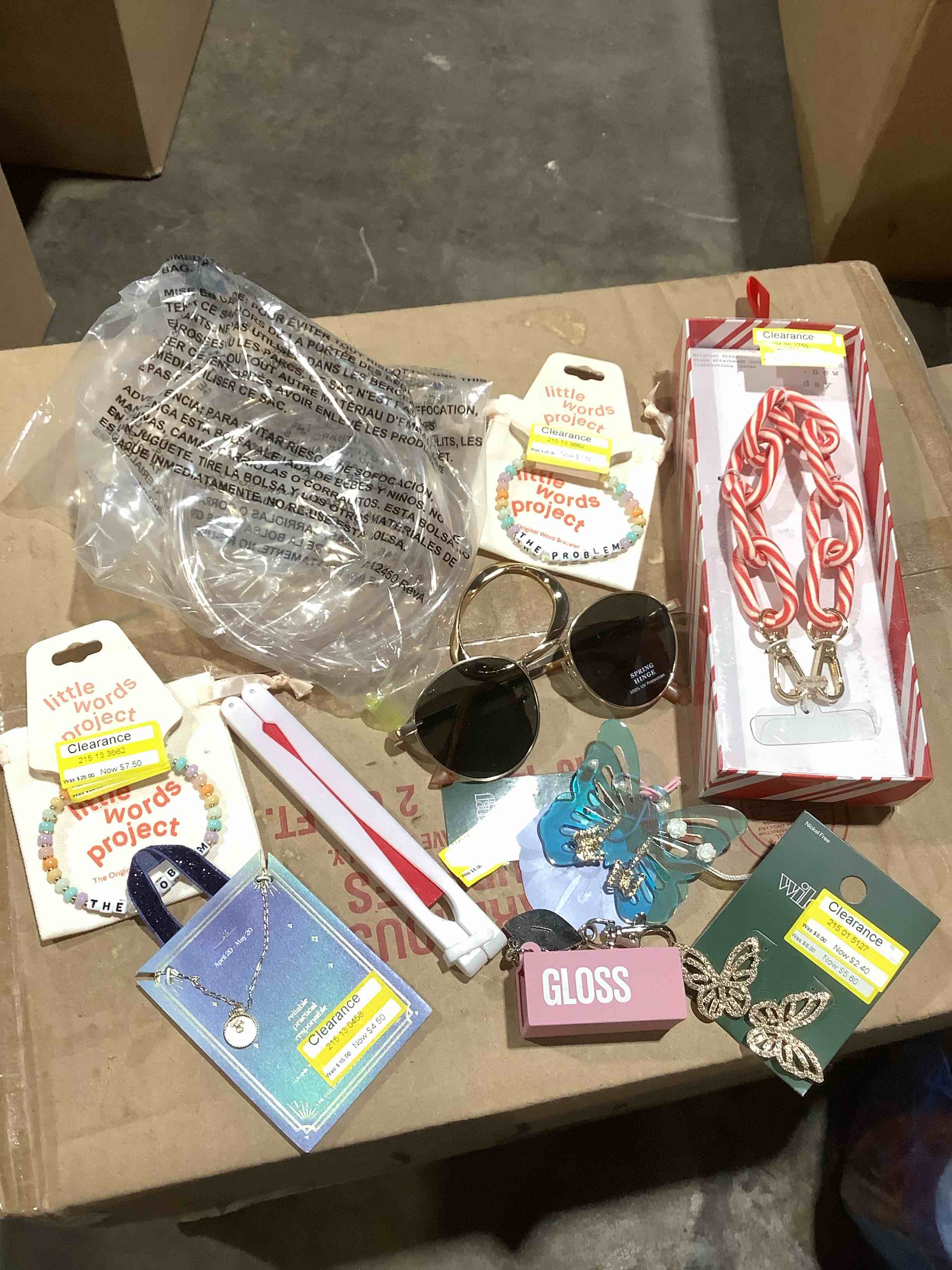 Assortment of this and that: wristlet strap for phone, sunglasses, jewelry, and more