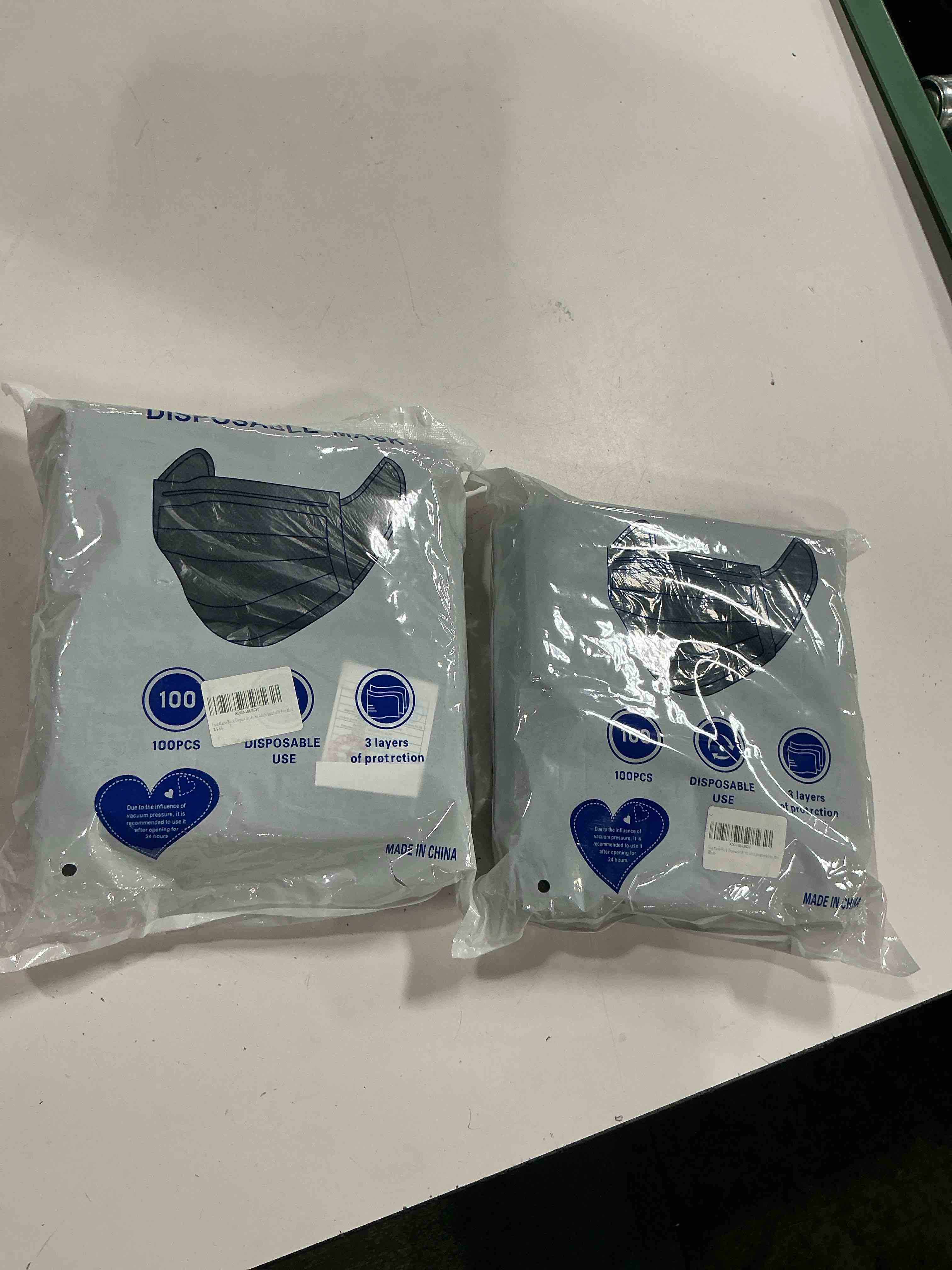 Condition photo showing New/Like New for 2 packs of black disposable masks, 200pcs