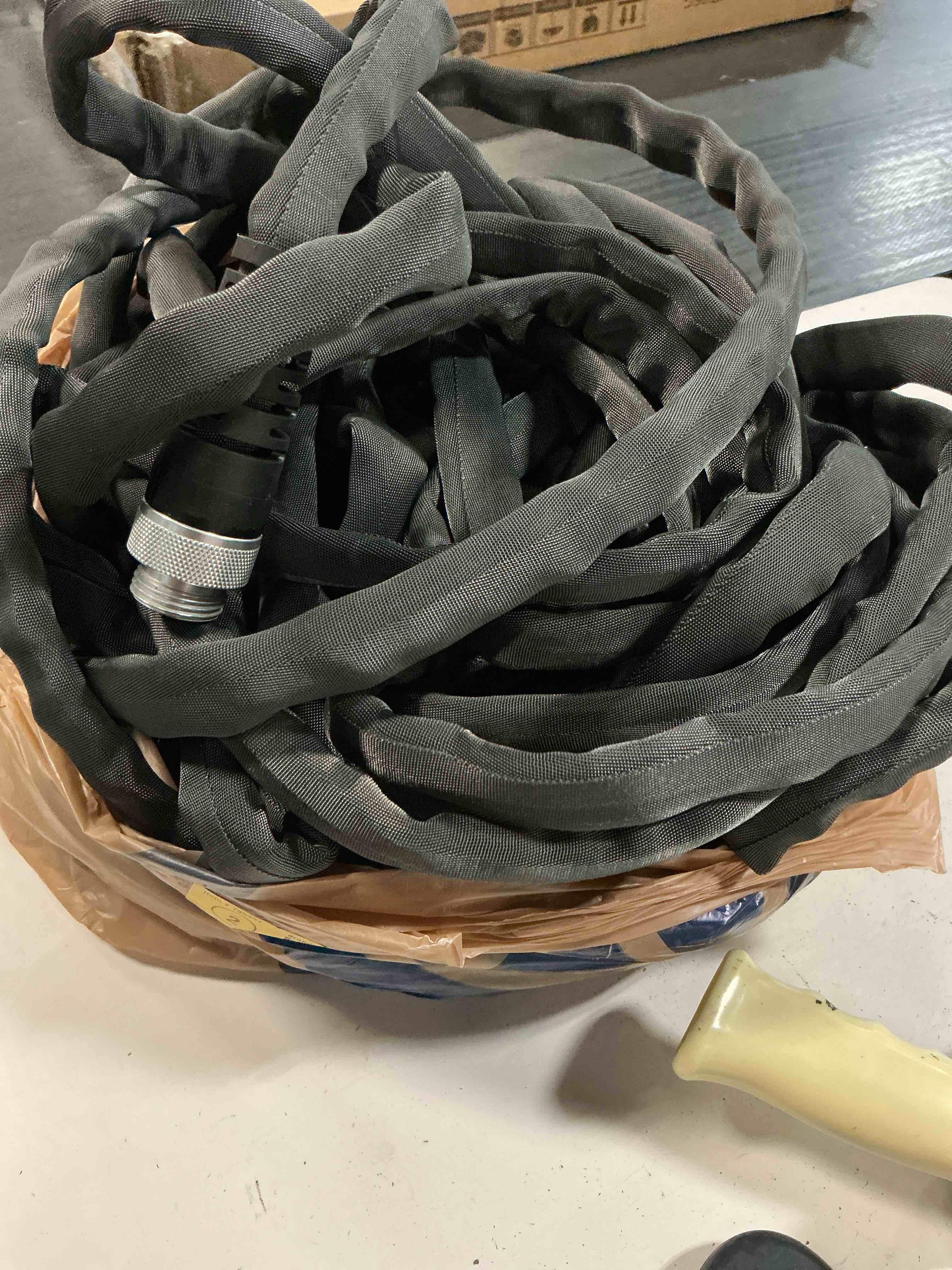 Condition photo showing As Is for zero-g teknor apex 5/8-in x 25-ft premium -duty kink free woven gray hose