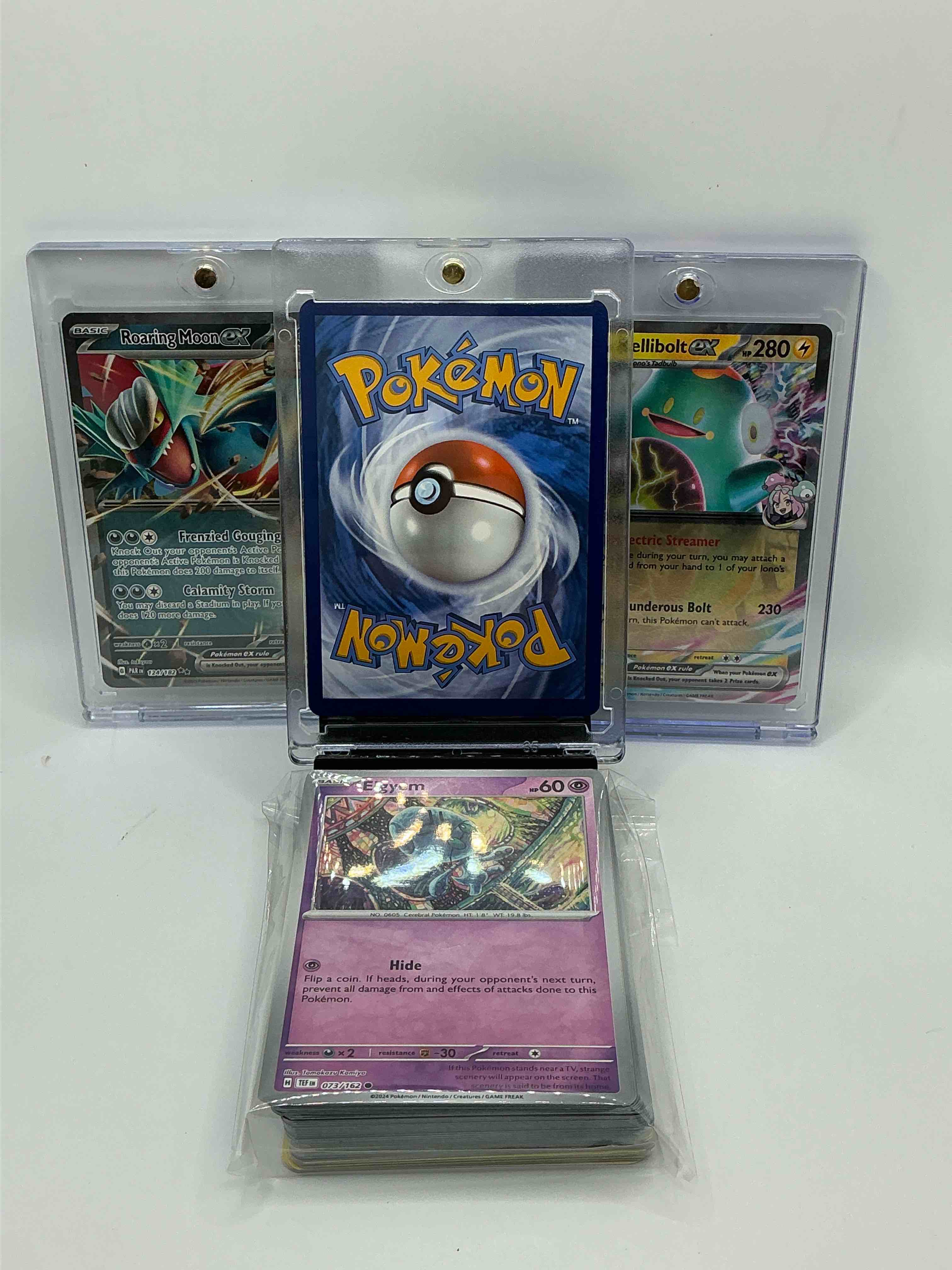 Condition photo showing New/Like New for pokémon! pikachu ex! roaring moon ex! along with 50 other pokémon heroes, holos, legends & commons- including holographic cards, stage 1 cards, holos & more! also includes 36 non holo common/ uncommon basic & first stage cards trainers & energy too! perfect set for collectors & enthusiasts!