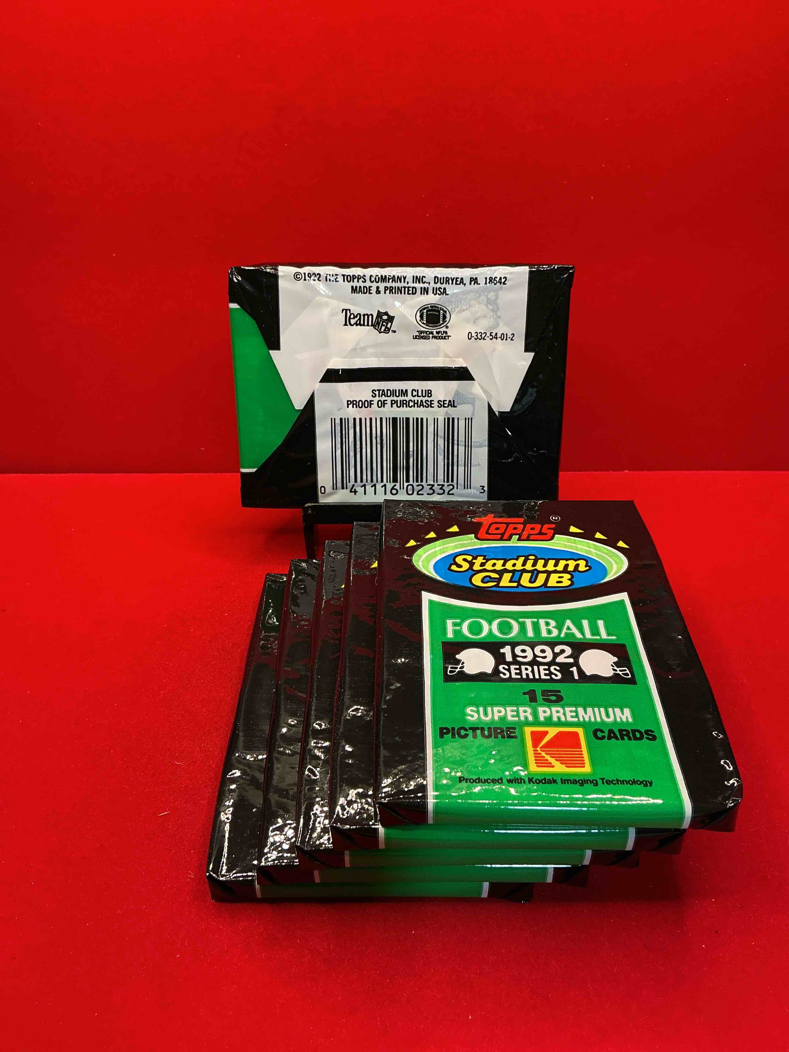 Condition photo showing New/Like New for rare! 1992 topps stadium club series 1 unopened wax pack, direct from original sealed retail case. sought after by collectors because each pack has a topps gold card! search for tons of stars like montana, rice, barry sanders, emmitt smith & so much more!