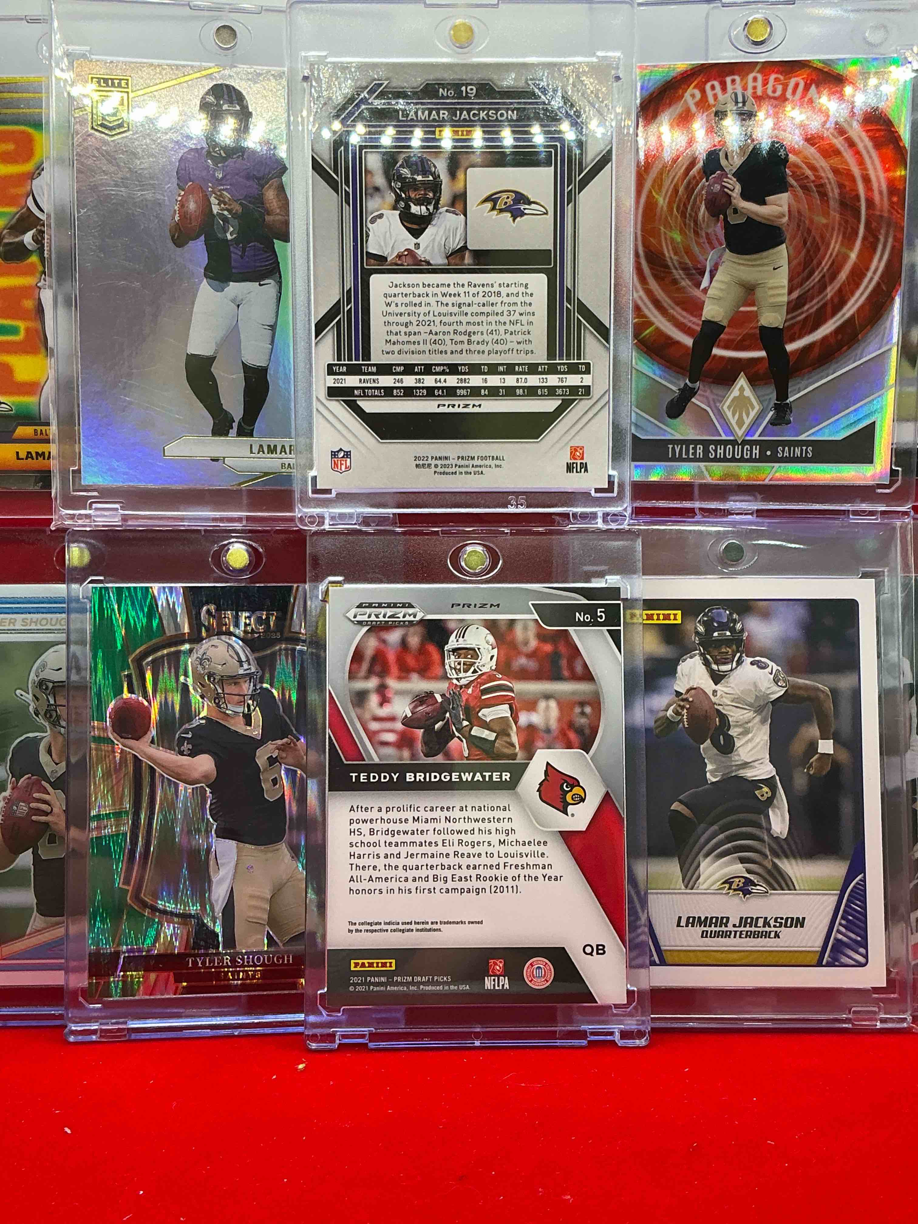Condition photo showing New/Like New for uofl quarterbacks! louisville legends! tyler shough rookie, lamar jackson cards & teddy bridgewater! wow! elite, prizms, select, phoenix, topps & more! insane! 10 cards!