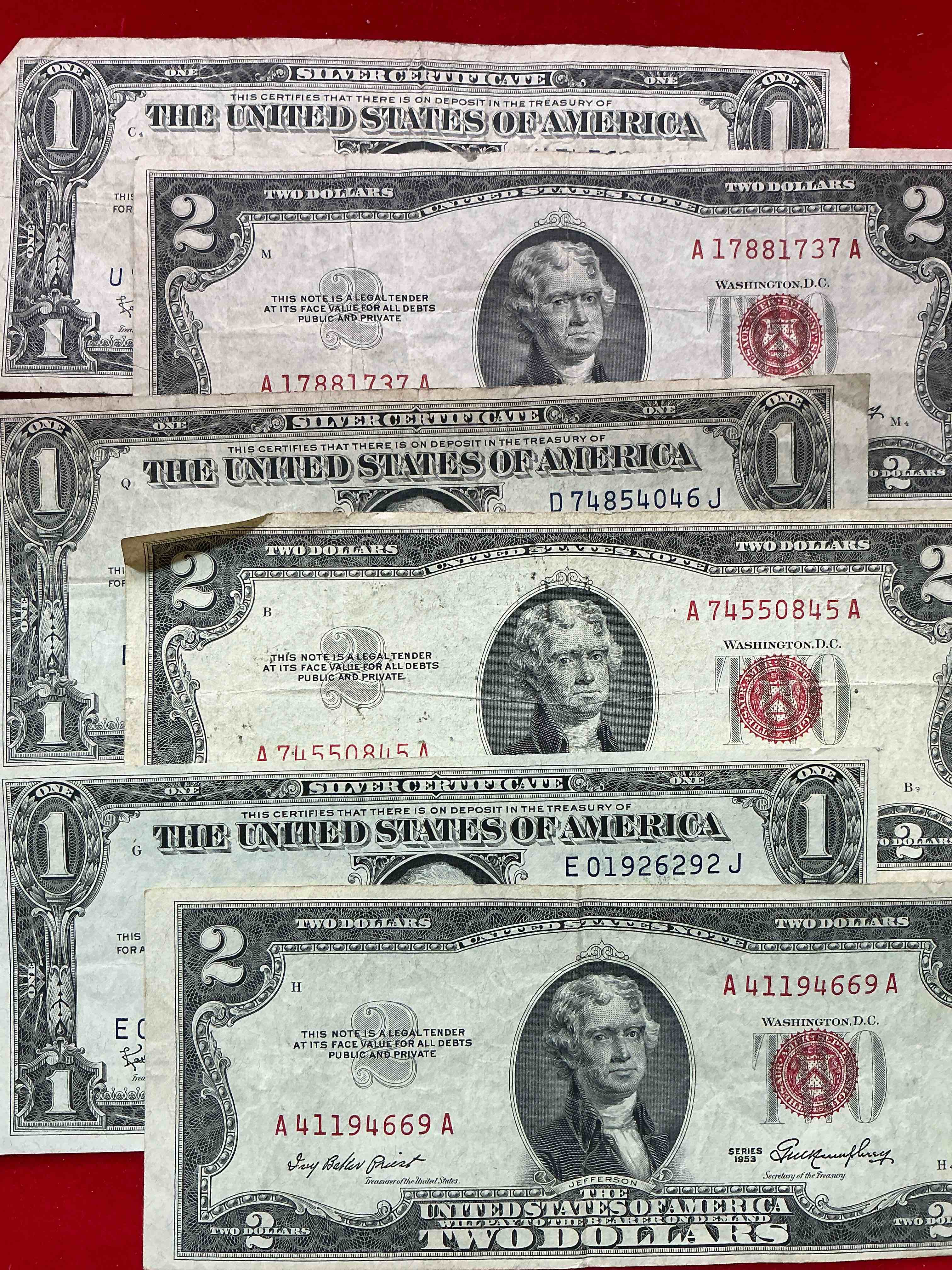 Condition photo showing Good Condition for rare american dollar bills! red seal two dollar bill, along with silver certificates! in good condition, red seal two dollar bill in good condition & silver certificates produced from 1878 to 1964 & are still considered legal tender at face value. here are gorgeous, circulated 1935 & 1957 u.s. one dollar silver certificate, with highly collectible "blue seal!” own an awesome piece of history! american dollar lot!