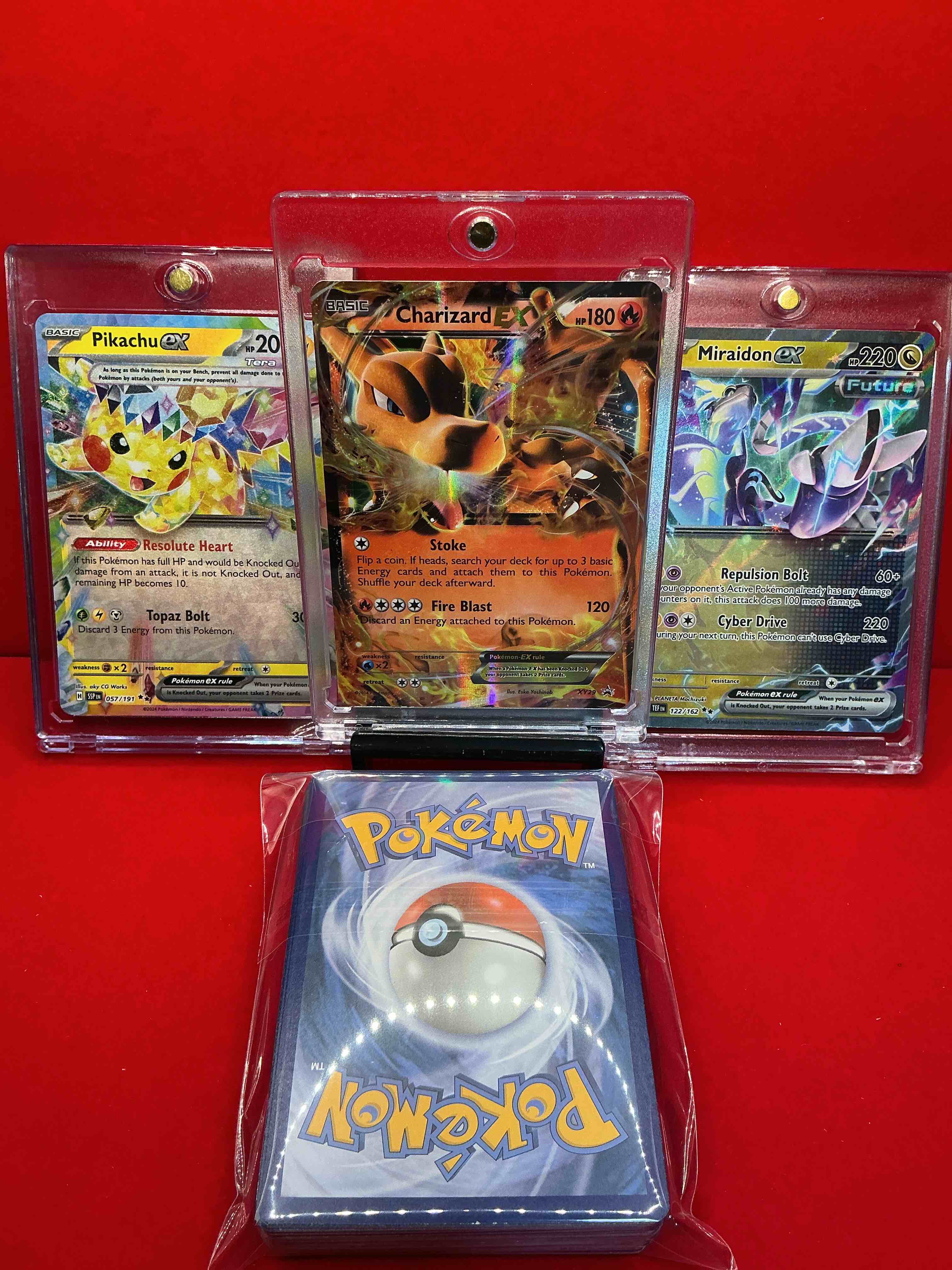 Condition photo showing New/Like New for pokémon! charizard ex! pikachu ex! miraidon ex! along with 50 other pokémon heroes, holos, legends & commons- including holographic cards, cool holos & more! includes non holo common/ uncommon basic & first stage cards & could even include trainers & energy too! perfect set for collectors & enthusiasts!