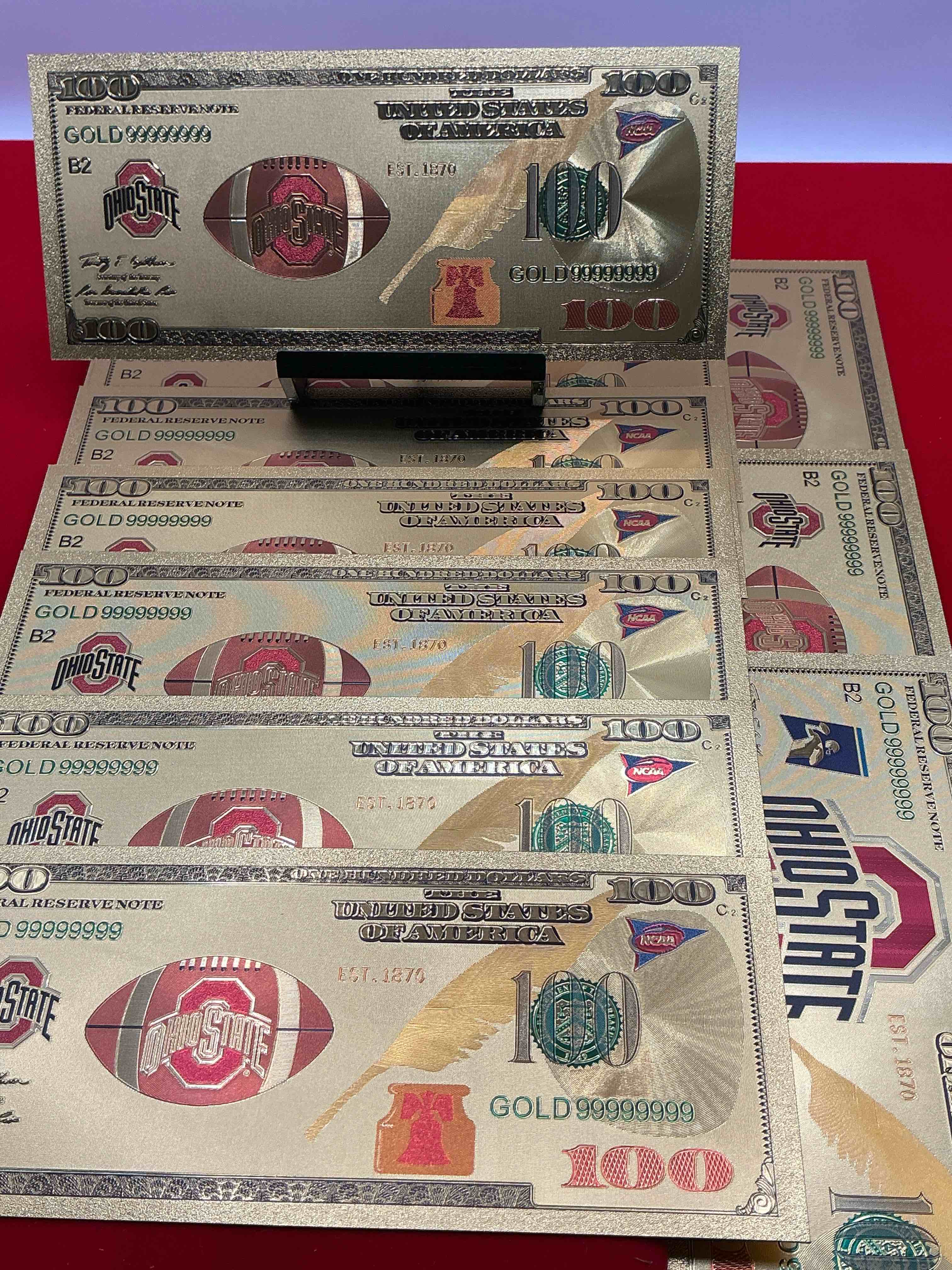 Condition photo showing New/Like New for ohio state university collectible memorabilia! super cool, gold in color 100 dollar commemorative ohio state university bill! cool designs on front & back of bill! osu fans rejoice, cool memorabilia! plastic bills with cool designs!