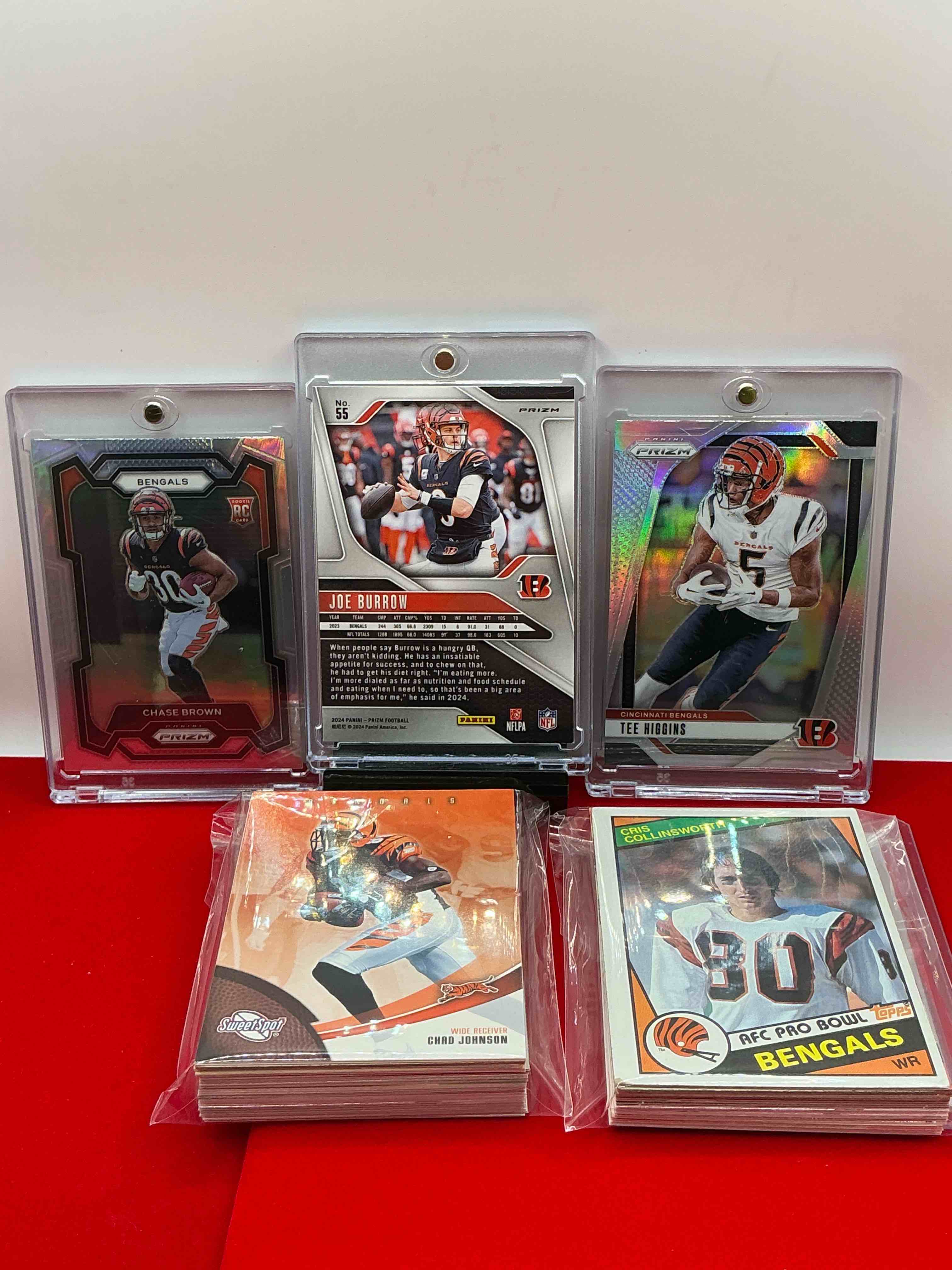 Condition photo showing New/Like New for bengals craziness! silver prizm trio! legends & heroes from all eras! 50 of the coolest bengals cards from every era! modern & vintage! joe burrow! tee higgins! cris collinsworth! so many more wow!