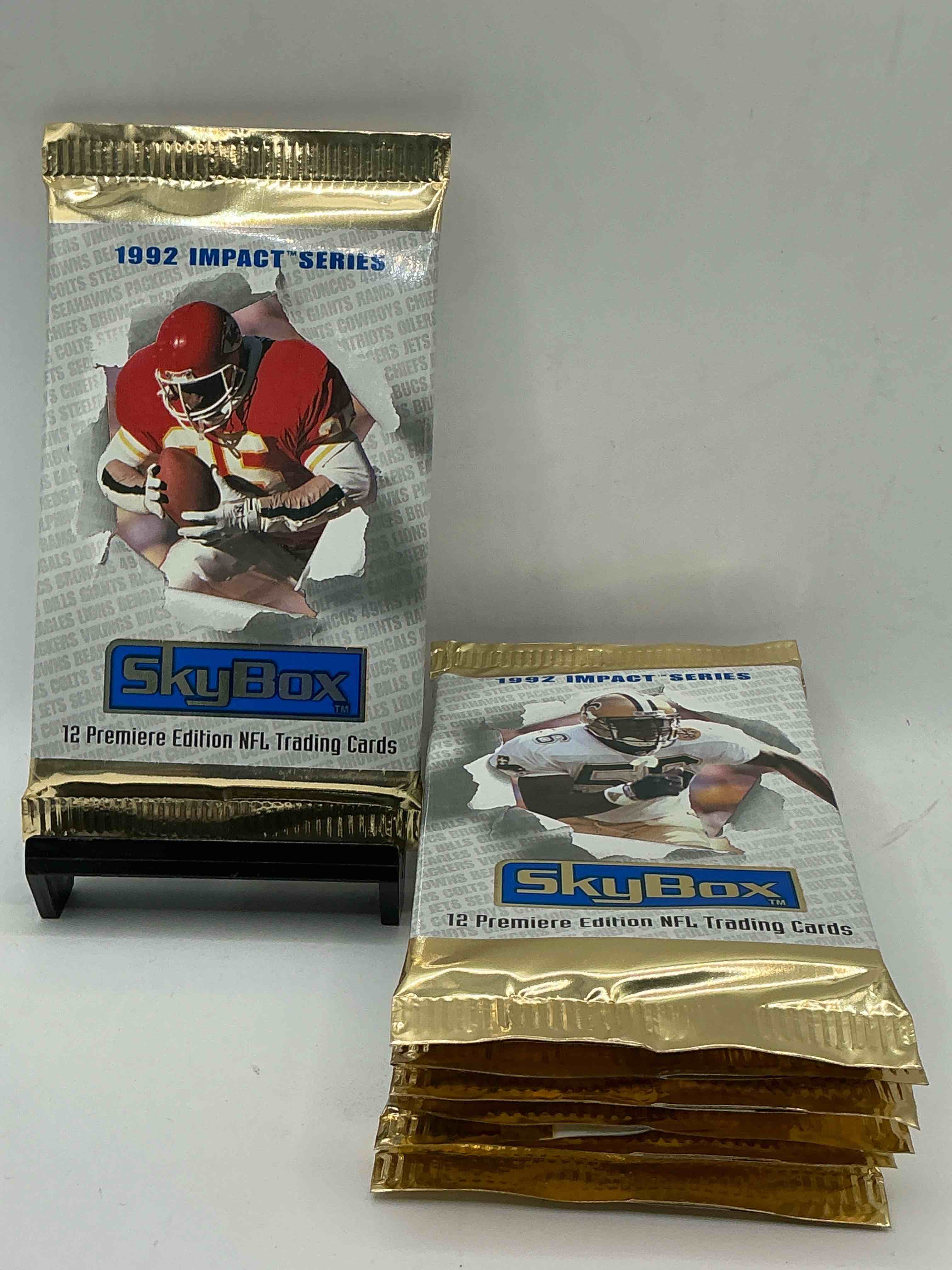 football insanity! 1992 skybox impact series premiere edition football card packs!all unopened & straight from box! high end cards! search for nfl stars brett favre, jim kelly, warren moon, joe montana, barry sanders & so many more, direct from original box!