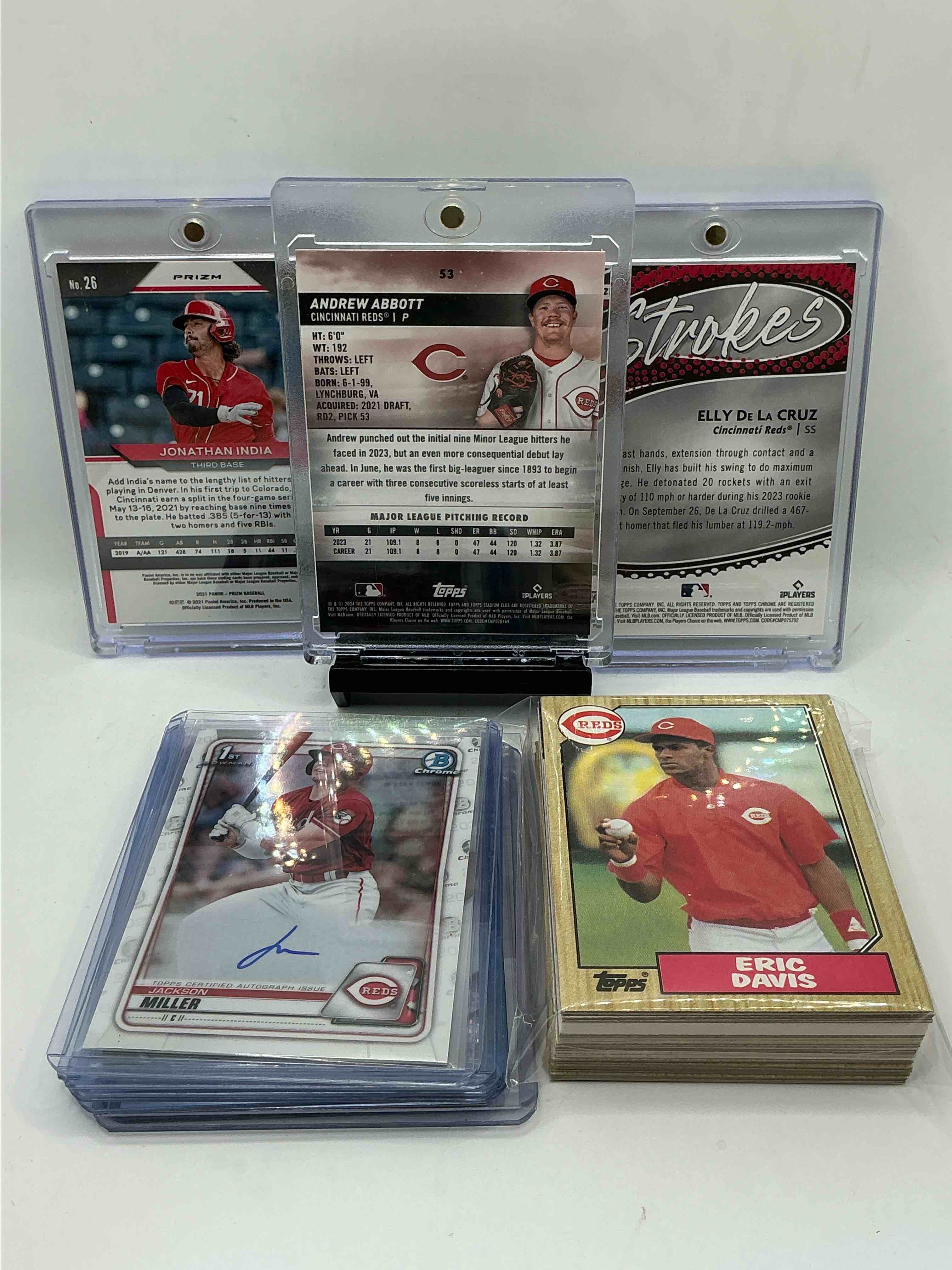 Condition photo showing New/Like New for reds rookie trio! 2024 topps stadium club chrome green rookie andrew abbot! 2024 topps chrome silver strokes rookie elly de la cruz! 2021 prizm red shimmer rookie jonathon india numbered 49/99! along with 50 other reds heroes, legends, rookies & commons!