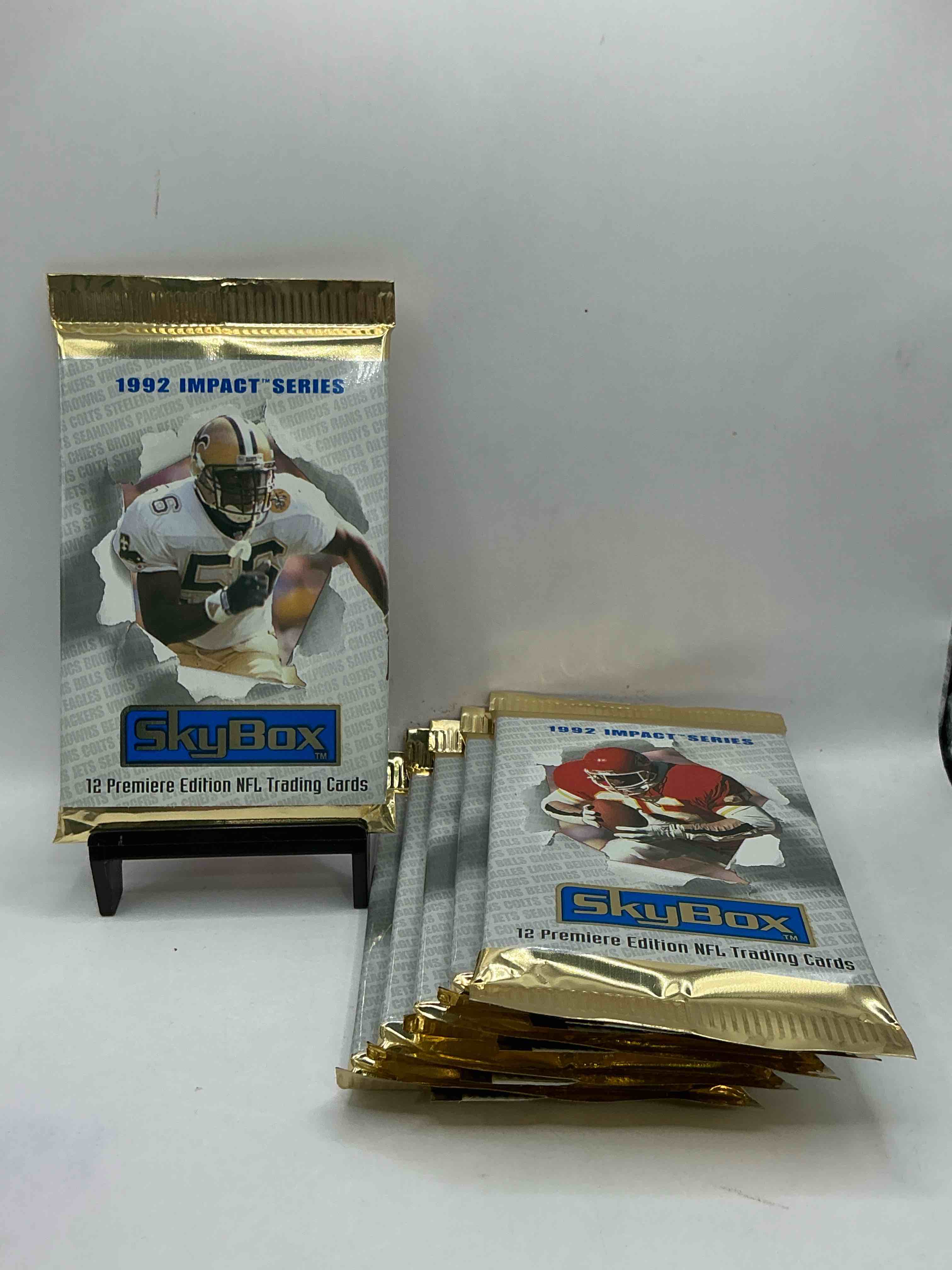 football insanity! 1992 skybox impact series premiere edition football card packs!all unopened & straight from box! high end cards! search for nfl stars brett favre, jim kelly, warren moon, joe montana, barry sanders & so many more, direct from original box!