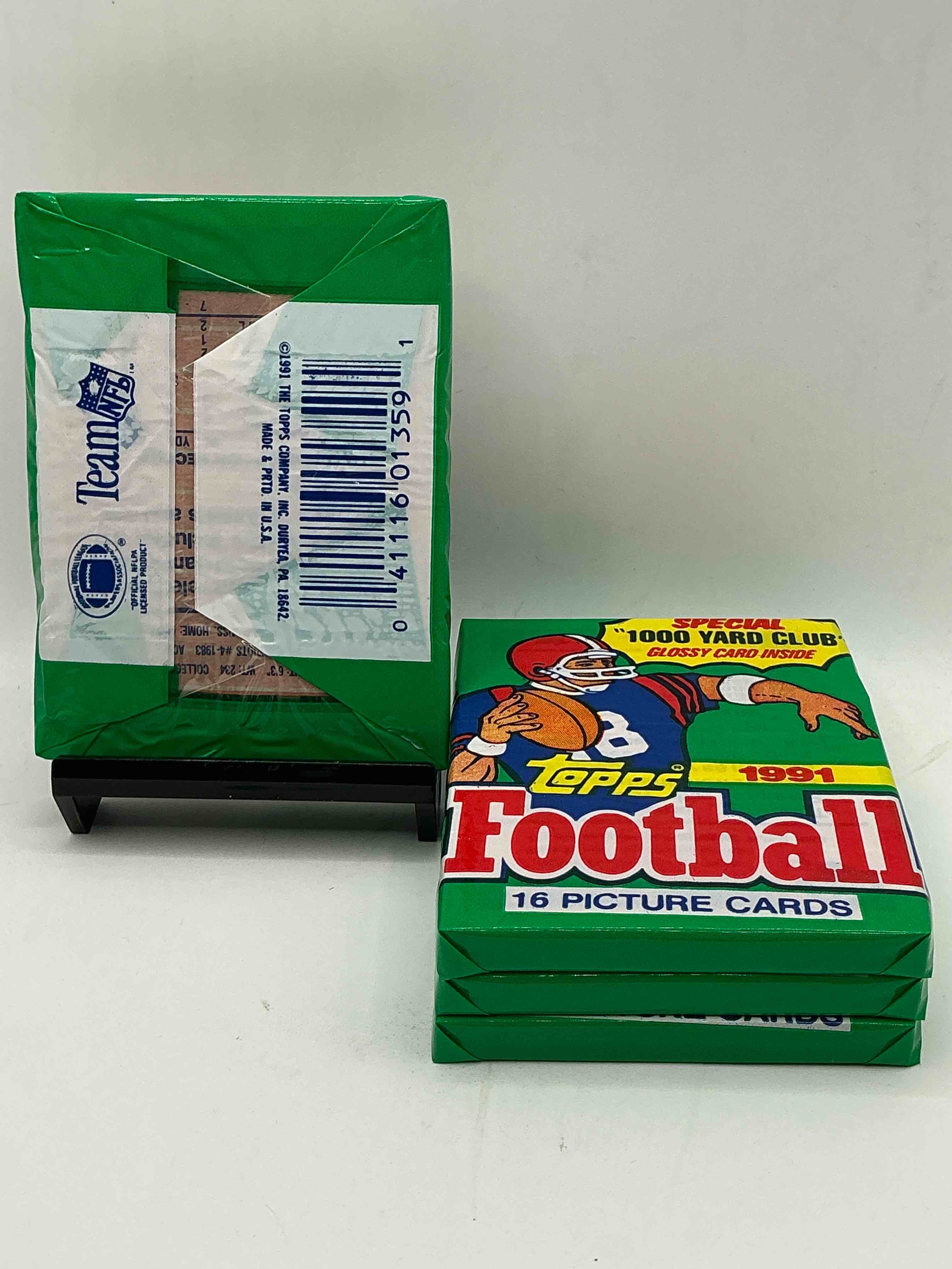 Condition photo showing New/Like New for 1991 topps football unopened sports card pack, direct from original retail case. search for early barry sanders, emmitt smith, jerry rice & joe montana!
