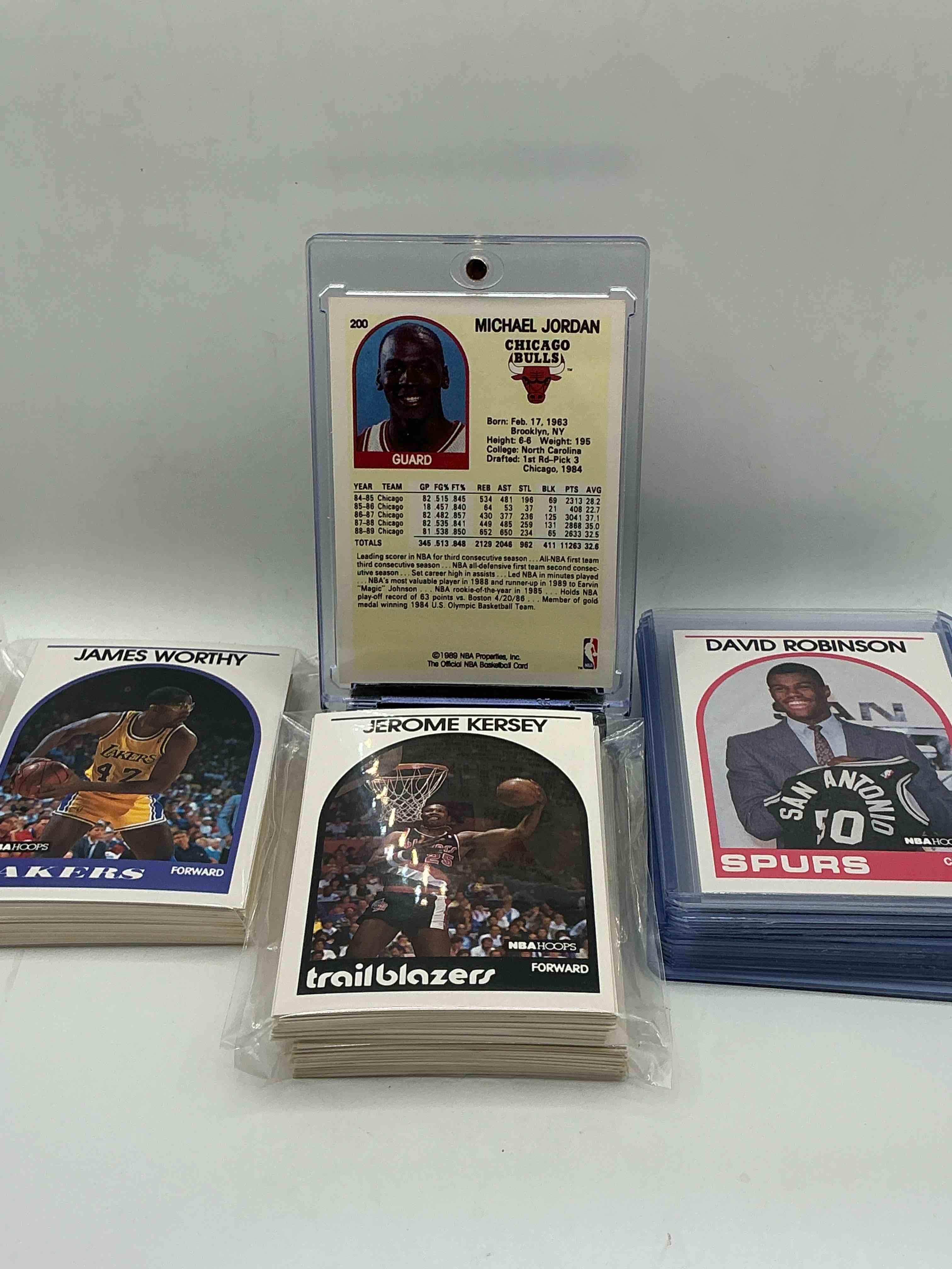 Condition photo showing New/Like New for 1989 nba hoops basketball! david robinson rookie! 1989 nba card combo! 50 of the best cards from the year & 50 more legends! michael jordan, magic johnson, larry bird, scottie pippen, charles barkley, john stockton, reggie miller, isiah thomas, akeem olajuwon, clyde drexler, karl malone & so many more! 100 card lot! all stars, hall of famers, champions & more, the perfect mix of miscellaneous '89 nba variety!