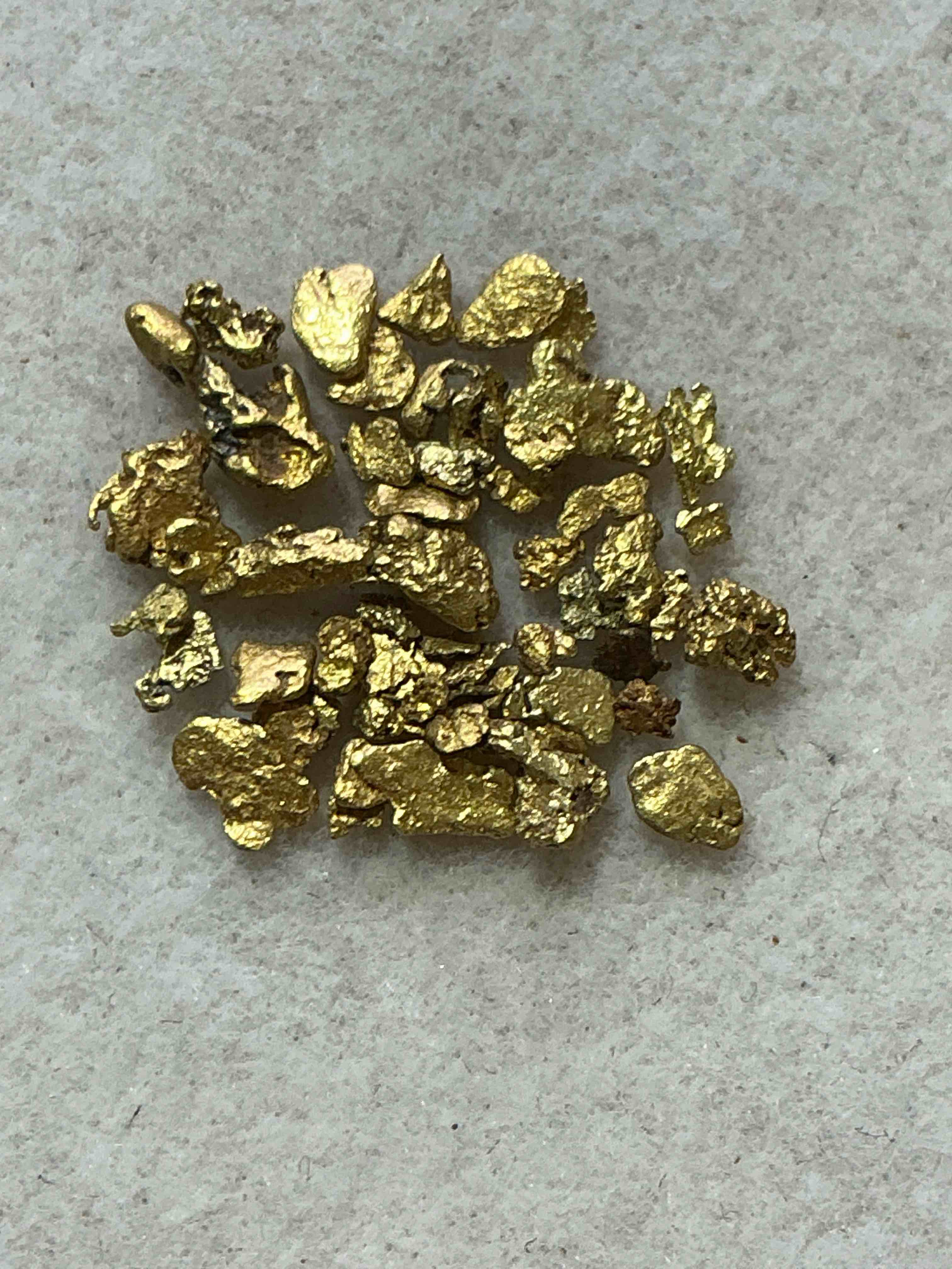 Approximately 1 Gram Genuine Gold Nuggets! Gold Nuggets Fresh From Prospecting North Carolina Mountains, Total Weight Of All Nuggets Is Approximately One Gram. These Gold Nuggets Typically Test At Between Approx 22-24 Karat. Gold In Raw, Prospected Form Is Extremely Hard To Find & Much Rarer Than Any Refined Form. Get In On The Gold Craze... Gold Has Increased In Value Over 40% Since 2025! U.S. Dime For Size Reference Only (not included). Gold Vile In Image Included. Own Genuine, Gold Nuggets! 