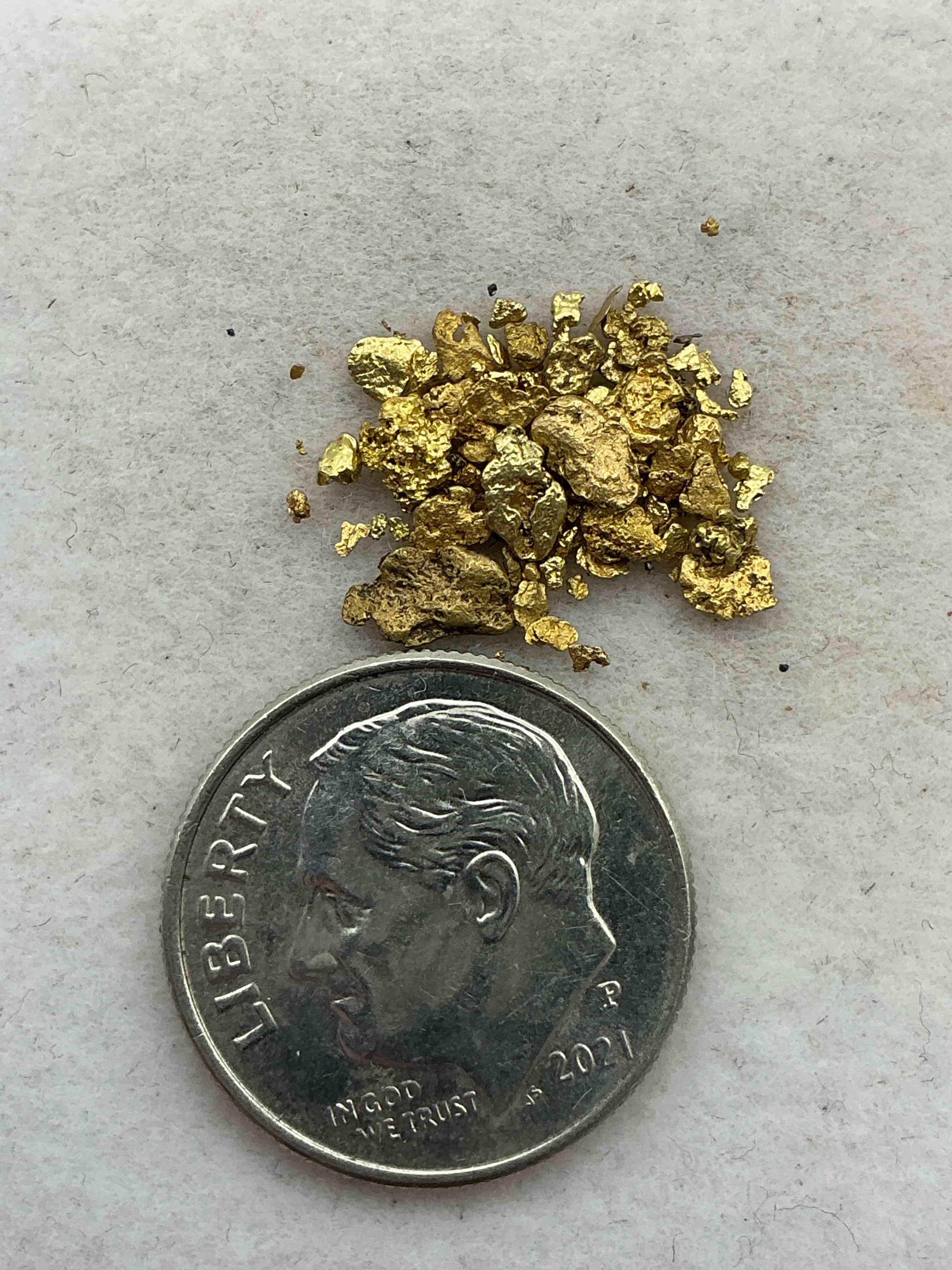 Condition photo showing Good Condition for approximately 1 gram genuine gold nuggets! gold nuggets fresh from prospecting north carolina mountains, total weight of all nuggets is approximately  this gold nugget tests at between approx 22-24 karat. gold in raw, prospected form is extremely hard to find & much rarer than any refined form. get in on the gold craze... gold has increased in value over 40% since 2025! u.s. dime for size reference only (not included). case in image included. own genuine, gold nuggets! 