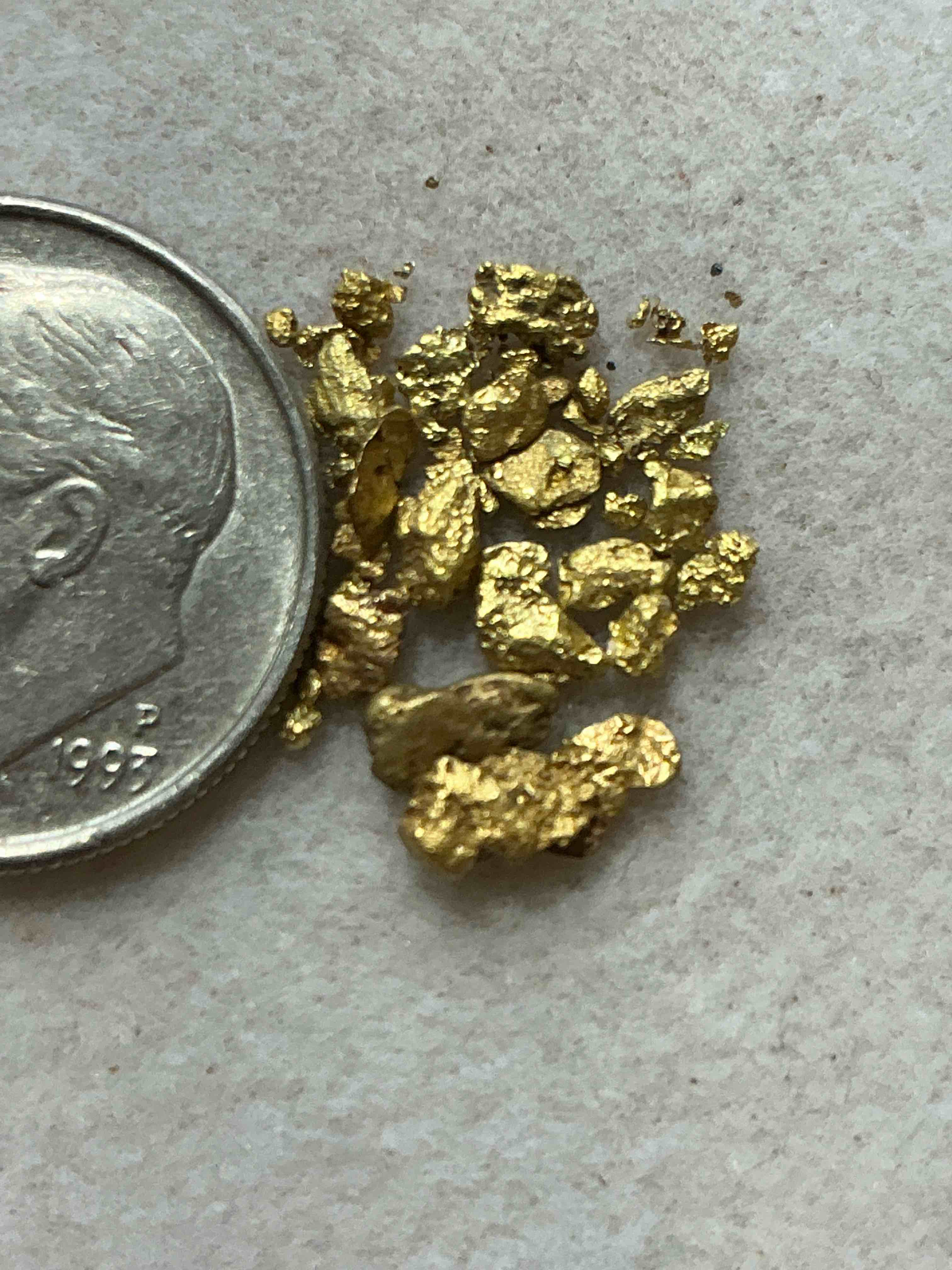 Condition photo showing New/Like New for half of a gram total genuine gold nuggets! gold nuggets fresh from prospecting north carolina mountains, total weight of all nuggets is approximately half of a gram. these gold nuggets typically test at between approx 22-24 karat. gold in raw, prospected form is extremely hard to find & much rarer than any refined form. get in on the gold craze... gold has increased in value over 40% since 2025! u.s. dime for size reference only (not included). gold vile in image included. own genuine, gold nuggets! 
