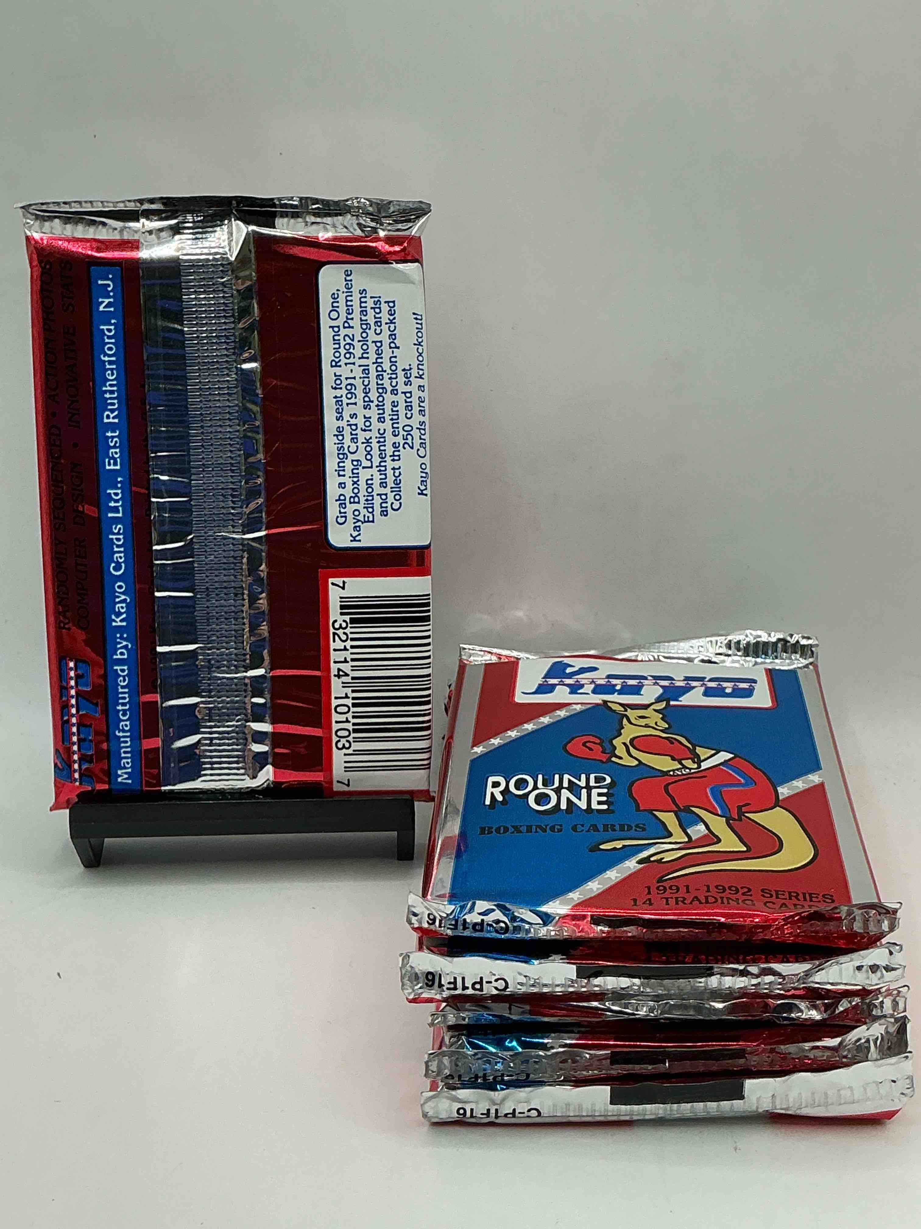 Condition photo showing New/Like New for boxing fans take notice! 1991-92 kayo round one boxing cards! 14 cards per pack! look for roy jones jr, lennox lewis, james toney & more! beautiful packs!