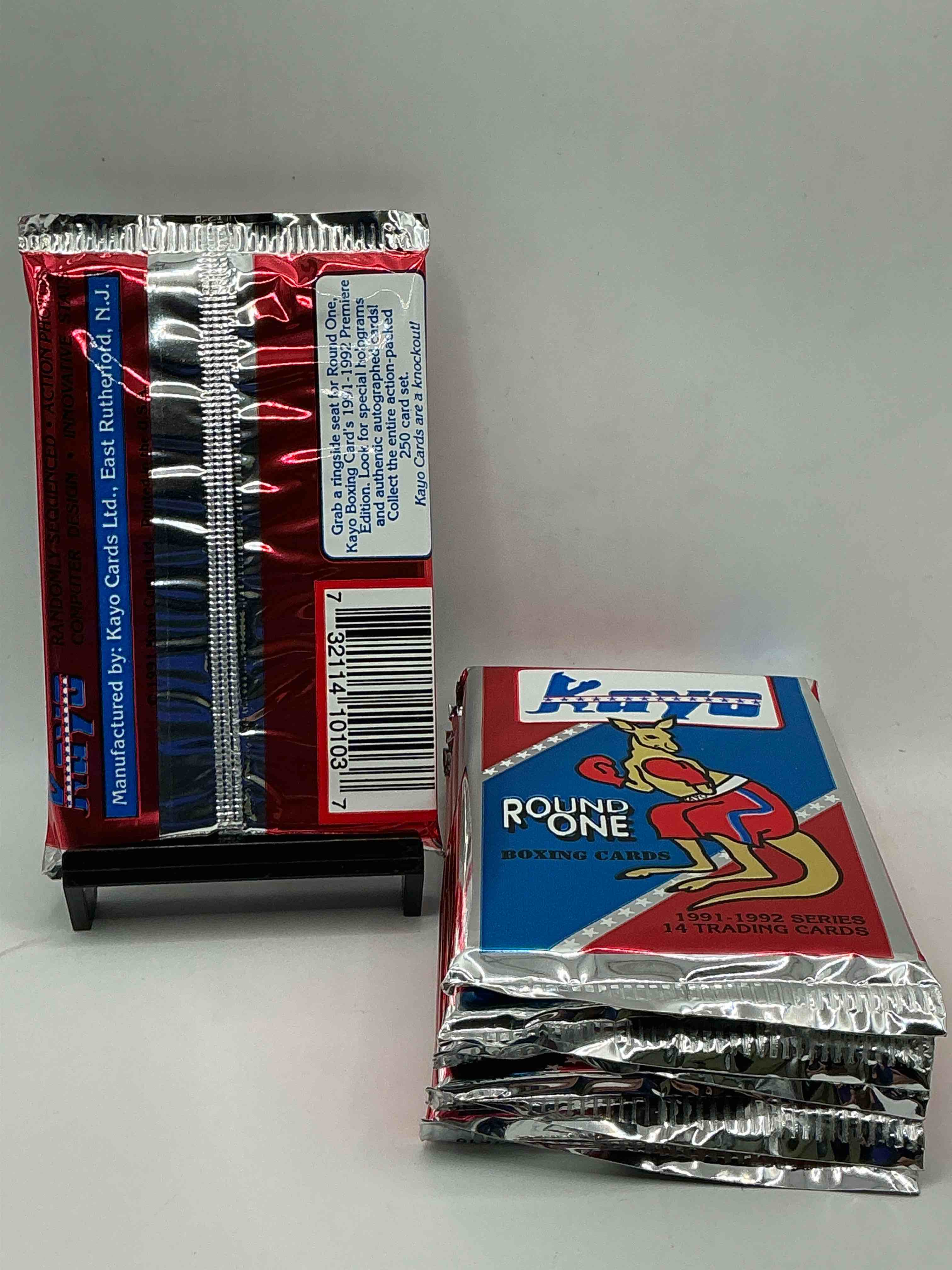 Condition photo showing New/Like New for boxing fans! 1991-92 kayo round one boxing cards! 14 cards per pack! look for roy jones jr, lennox lewis, james toney & more! beautiful packs!