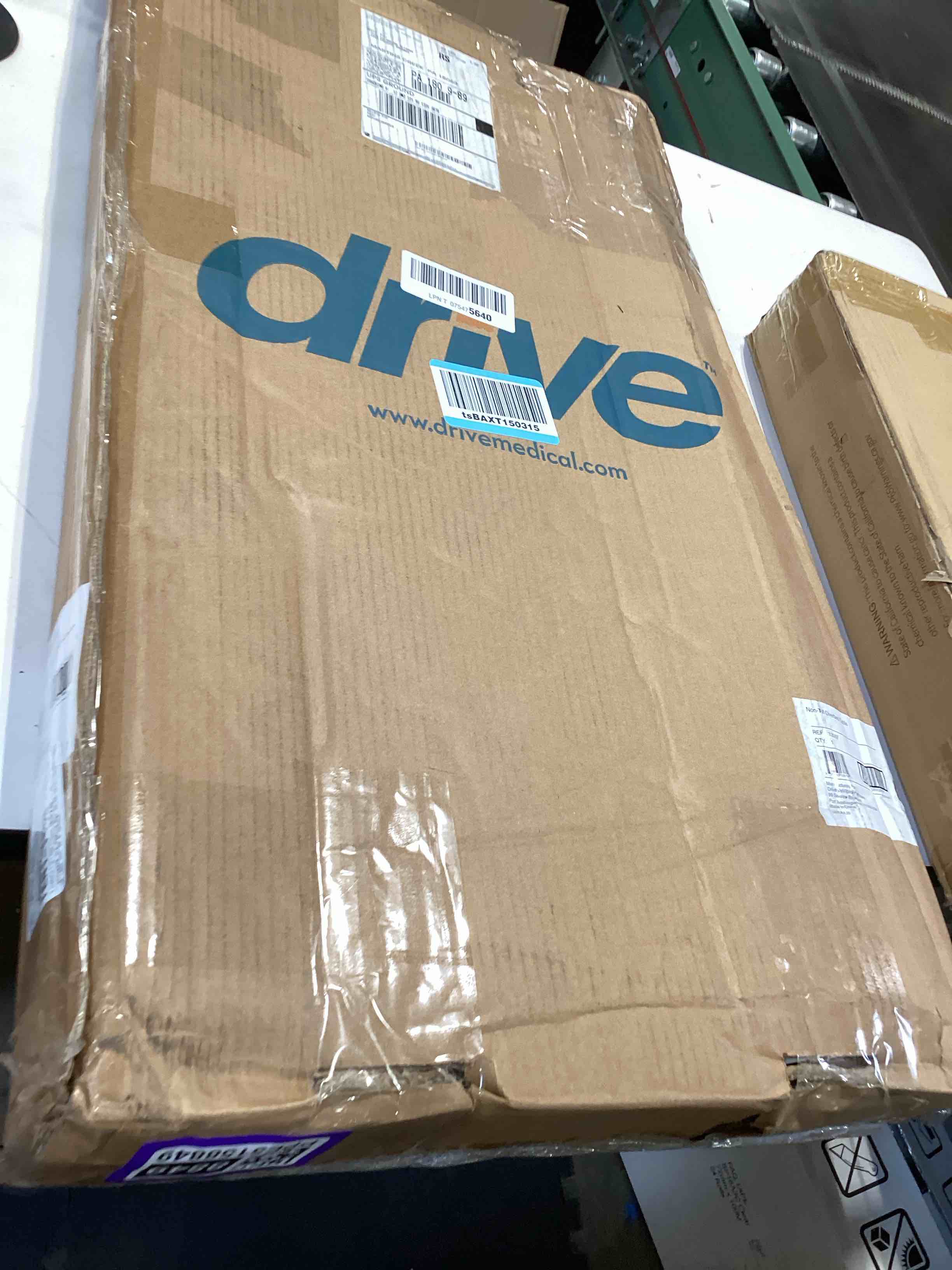 Condition photo showing Good Condition for drive medical overbed table with wheels - secure height adjustment for comfort - non tilt surface - smooth rolling design - home & hospital use - woodgrain laminate top - silver vein silver vein table