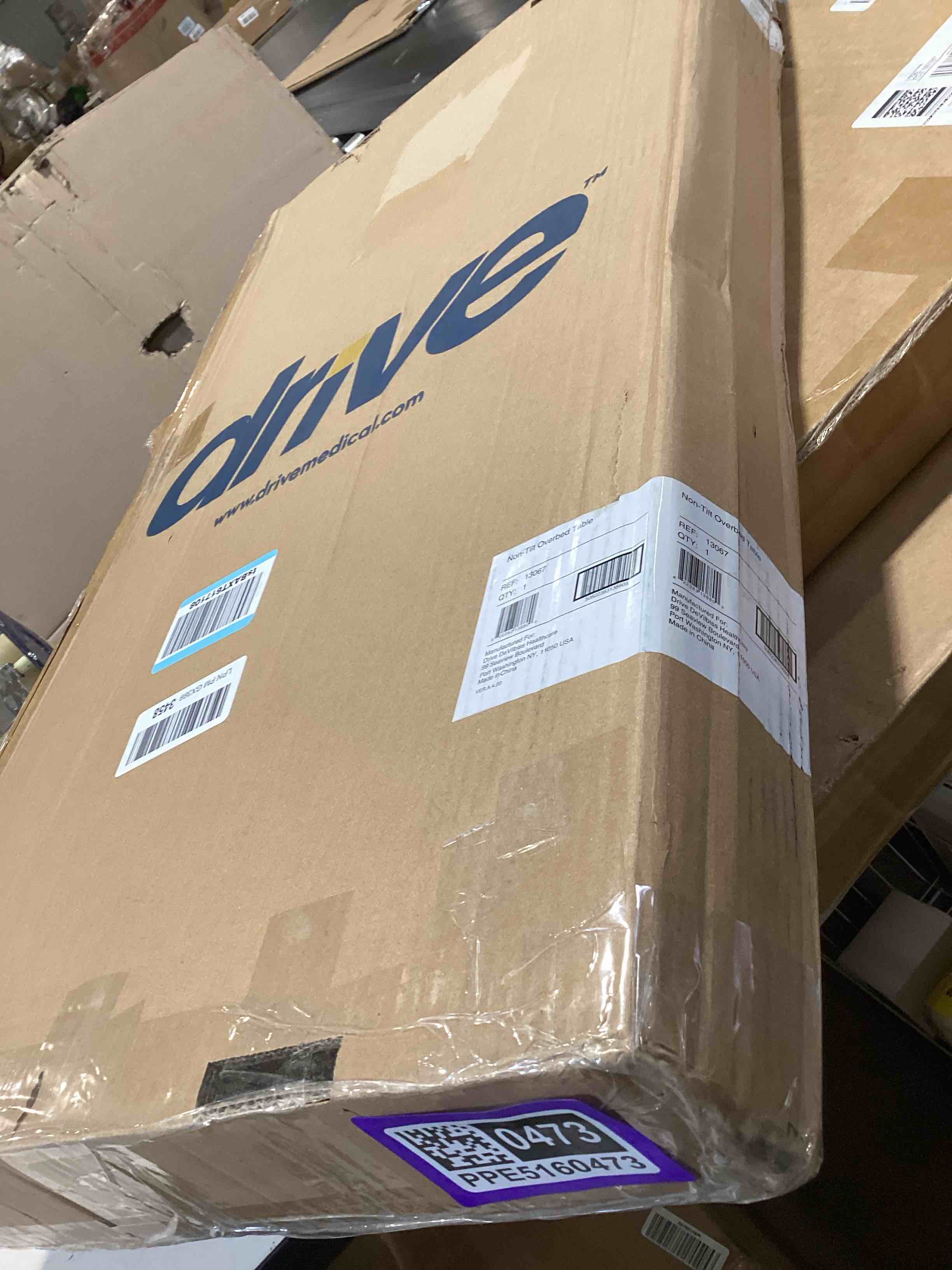 Condition photo showing Good Condition for drive medical overbed table with wheels - secure height adjustment for comfort - non tilt surface - smooth rolling design - home & hospital use - woodgrain laminate top - silver vein silver vein table