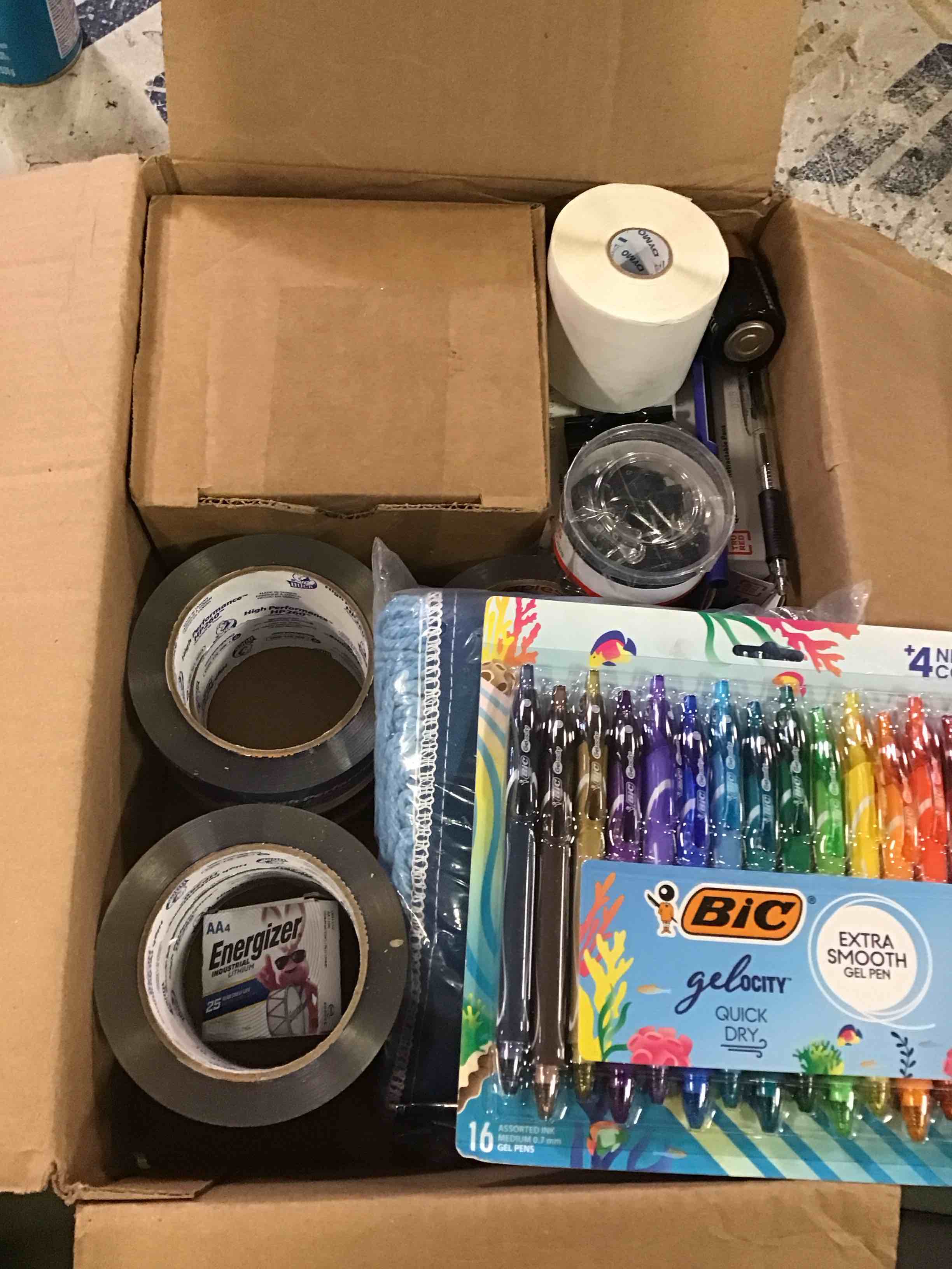 assorted office supplies including pens, paper clips , tape and more