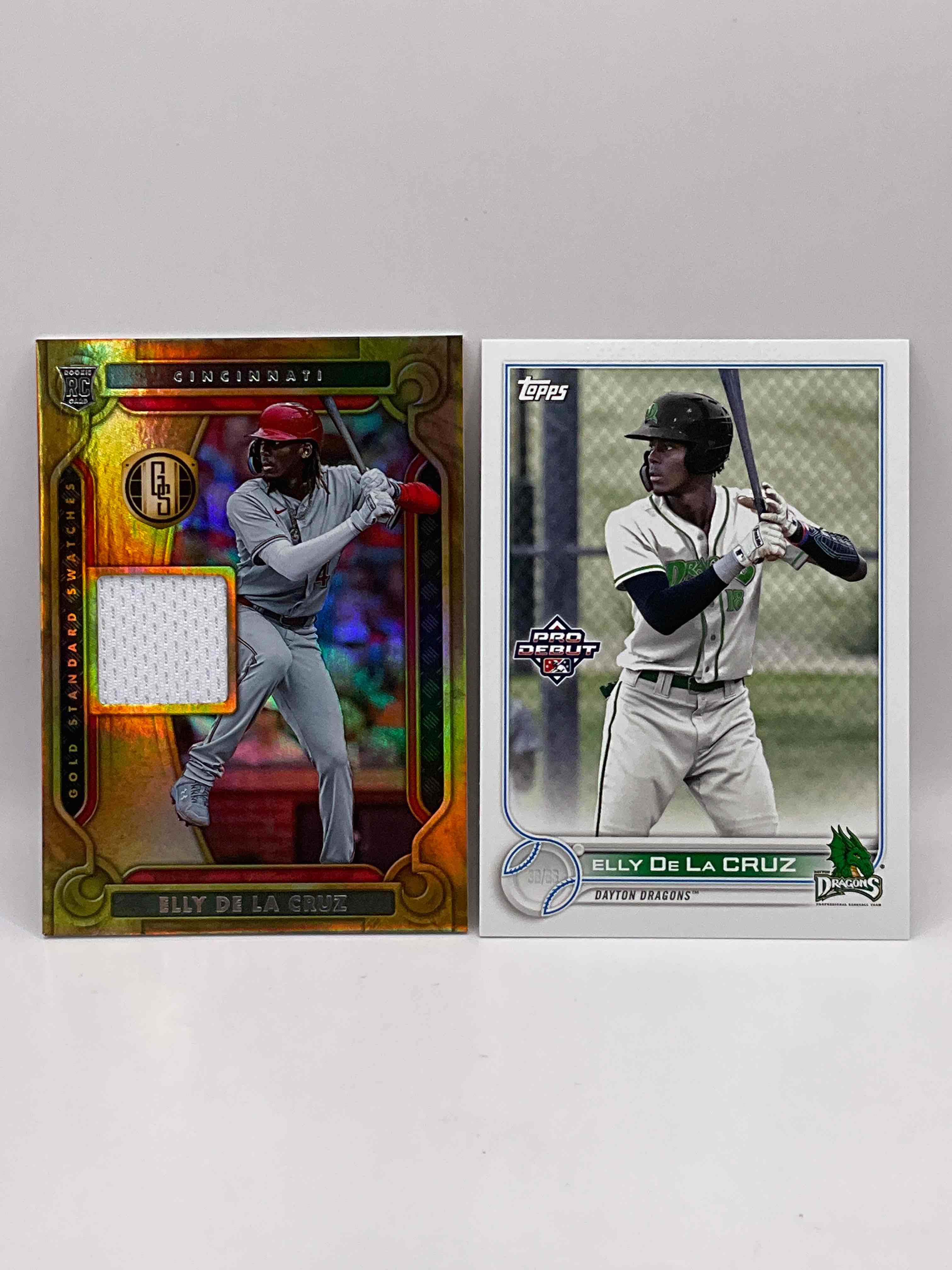 Wow! Premium Elly De La Cruz Rookie Card Bundle! De La Cruz “Gold Standard Swatches” Gold Rookie Card & Topps Pro Debut Rookie Card! Both Mint!