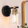Modern Black Wall Sconce 1-Light Bathroom Powder Room Vanity Light with Plated Brass Accents and Bell Clear Glass Shade