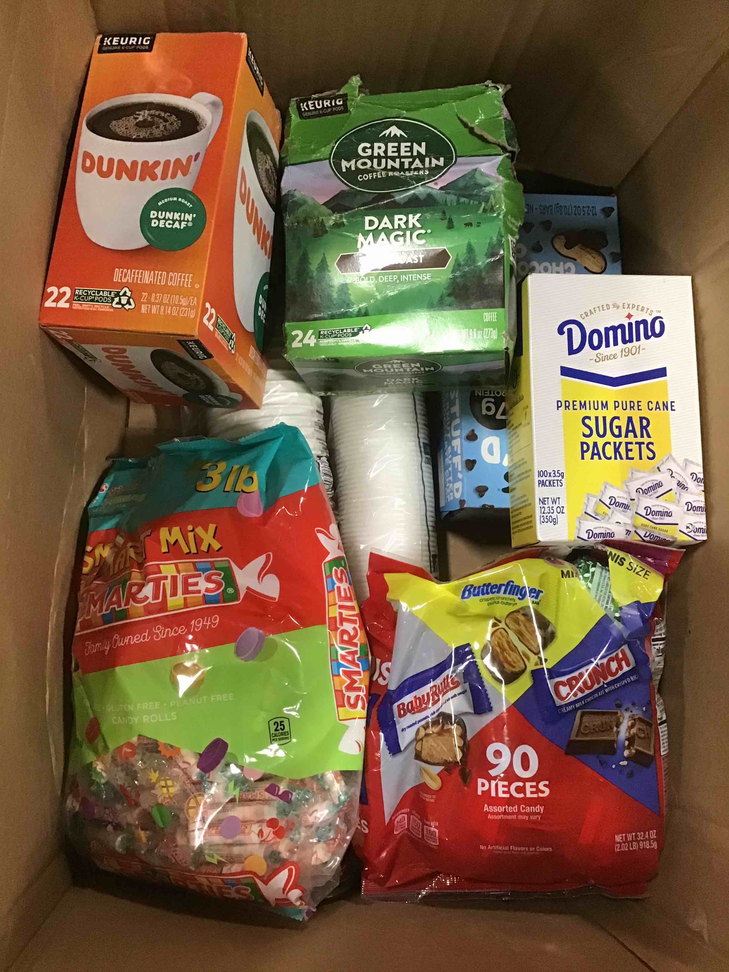 Assorted break room supplies: sugar, smarties, chocolates and more 