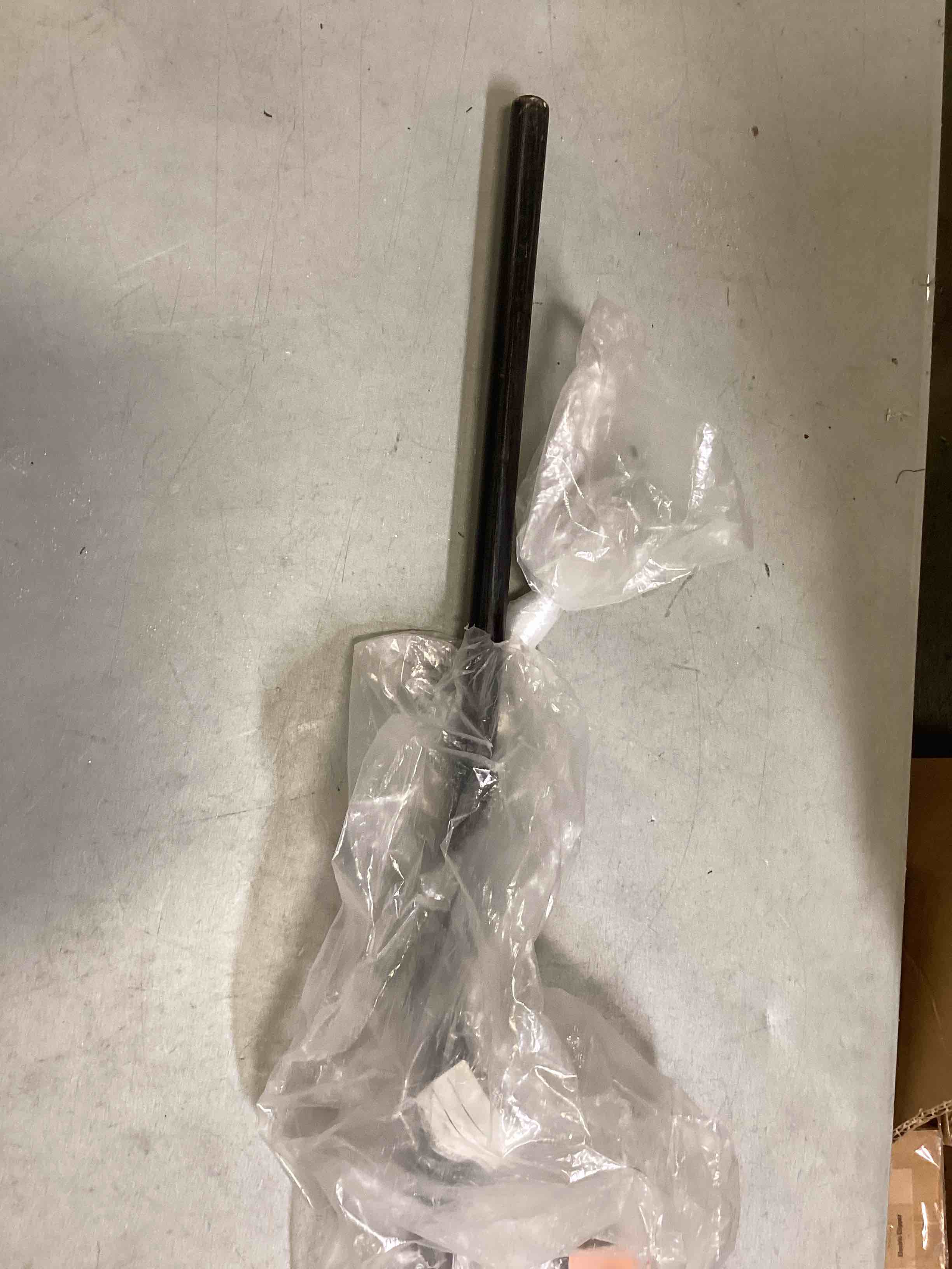 small straw broom with black stick handle 