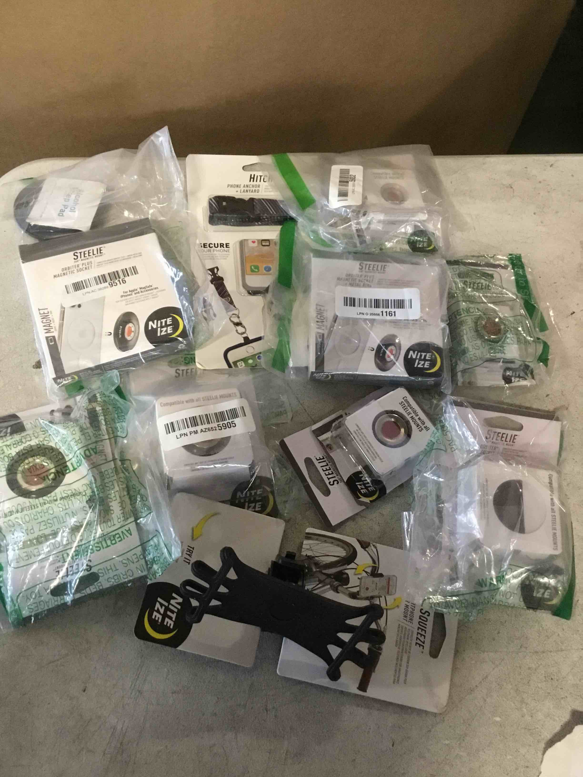 ASSORTED OF ACCESSORIES  FOR  IPHONE INCLUDED, SQUEESE ROTATING SMARTPHONE BAR MOUNT,MAGNETIC PHONE SOCKET PLUS ,HITCH PHONE ANCHOR LANYARD STEELIE ORBITER MEGNETIC SOCKET METAL RING AND MORE