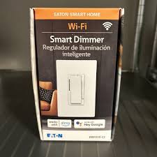 Eaton Wi-Fi Smart Dimmer, model EWFD30-C2. It is a device that replaces standard light switches and allows for remote control of lights via Wi-Fi. Key features include:  Remote Control: Operates lights from anywhere using the Brightlayer Home App.  Dimming Function: Offers dimming and brightening capabilities.  Smart Home Integration: Compatible with Alexa and Google Assistant for voice control.  Flicker Prevention: Features trim settings to minimize flickering.  Easy Setup: Designed for quick and easy installation.  Wiring: Requires direct wiring to the light fixture, and incorrect wiring can cause damage.  Wi-Fi: Operates on a 2.4 GHz Wi-Fi network. 