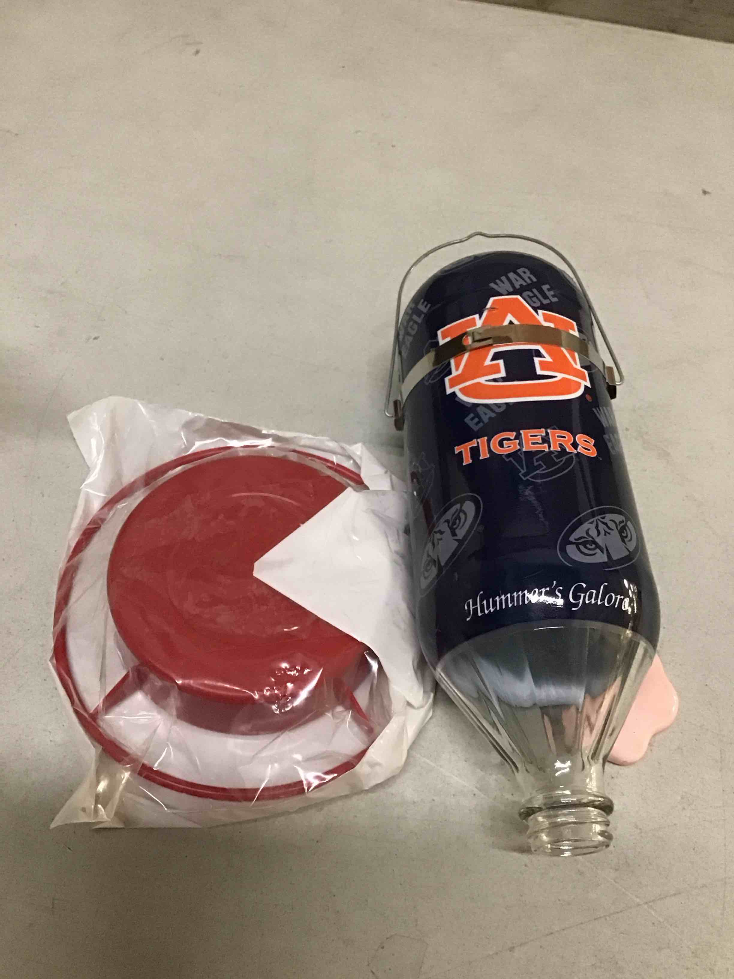 Condition photo showing New/Like New for Hummer's Galore, NCAA College Football Hummingbird Feeder, Glass Hummingbird Feeder with UV Resistant Plastic Wrap for Outdoors Hanging, 32 oz, (Auburn Tigers)