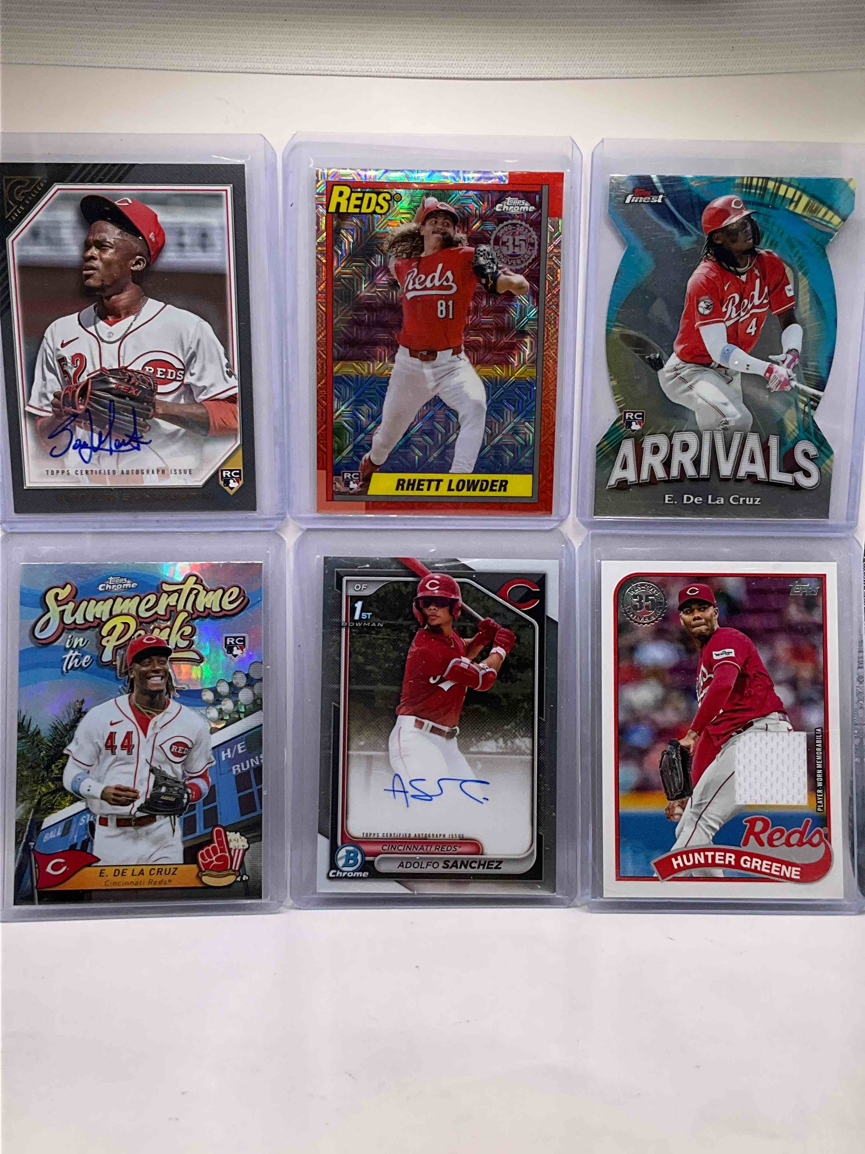 Prestigious Reds Bundle! Summertime in the Park Elly De La Cruz Rookie Card, Topps Finest Rookie Card, Reiver Sanmartin Signed Rookie Card, Adolfo Sanchez Signed 1st Bowman Chrome Card (Rare), Rhett Lowder Topps Chrome Rookie & Hunter Greene Game Worn Jersey Card! All Mint!