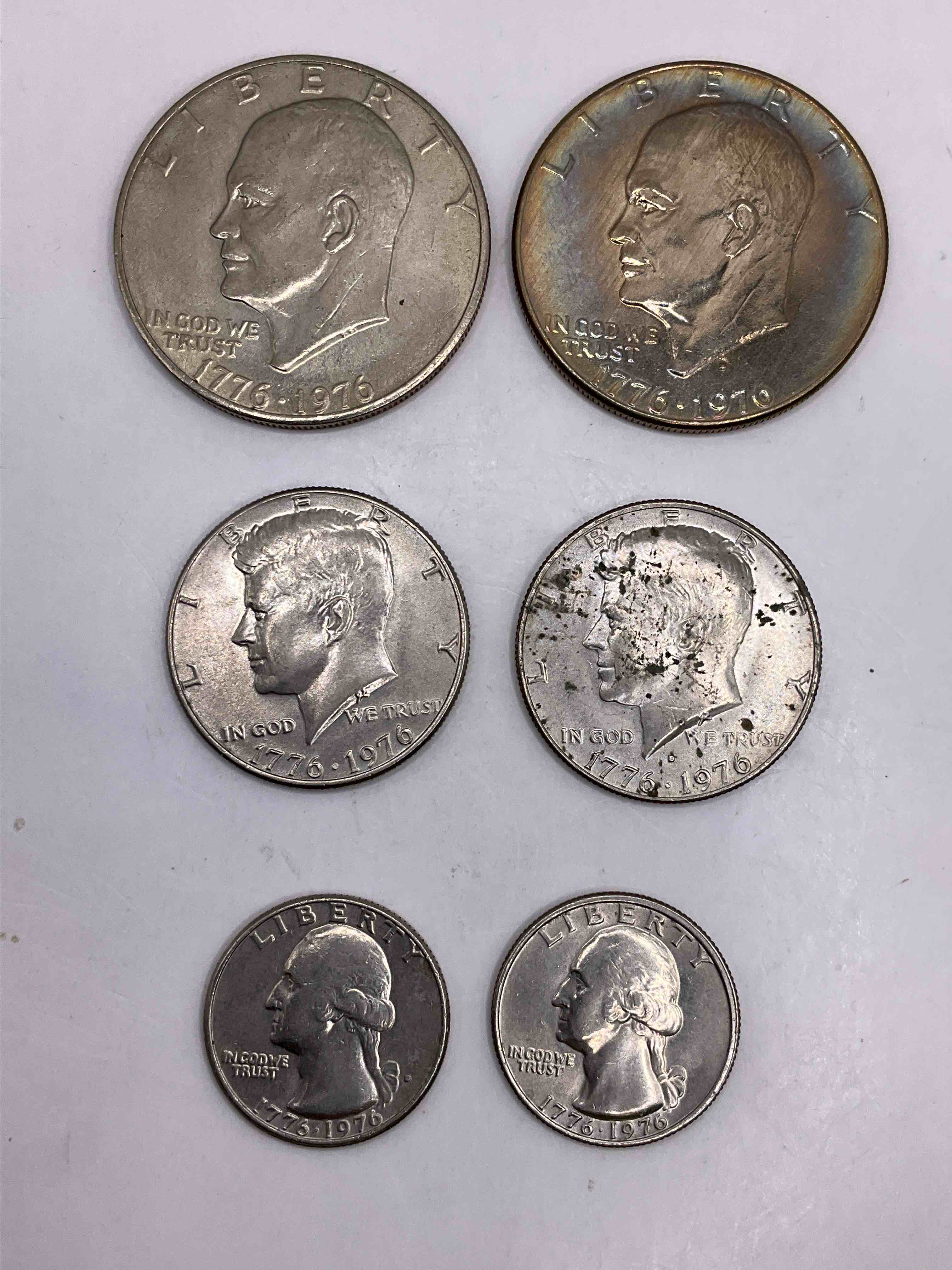 1976 Bicentennial Bliss! In 1976 The U.S. Mint Produced Coins Celebrating The 200 Year Anniversary Of America. Up For Auction Are Awesome Examples Of All Three Coins Produced For This... The Quarter, Half Dollar & Dollar Coin! Dollar Coins Show Great Toning, Highly Desirable For Collectors! Own Pieces Of History & Get Ready For America's 250 Year Anniversary Coming Soon!