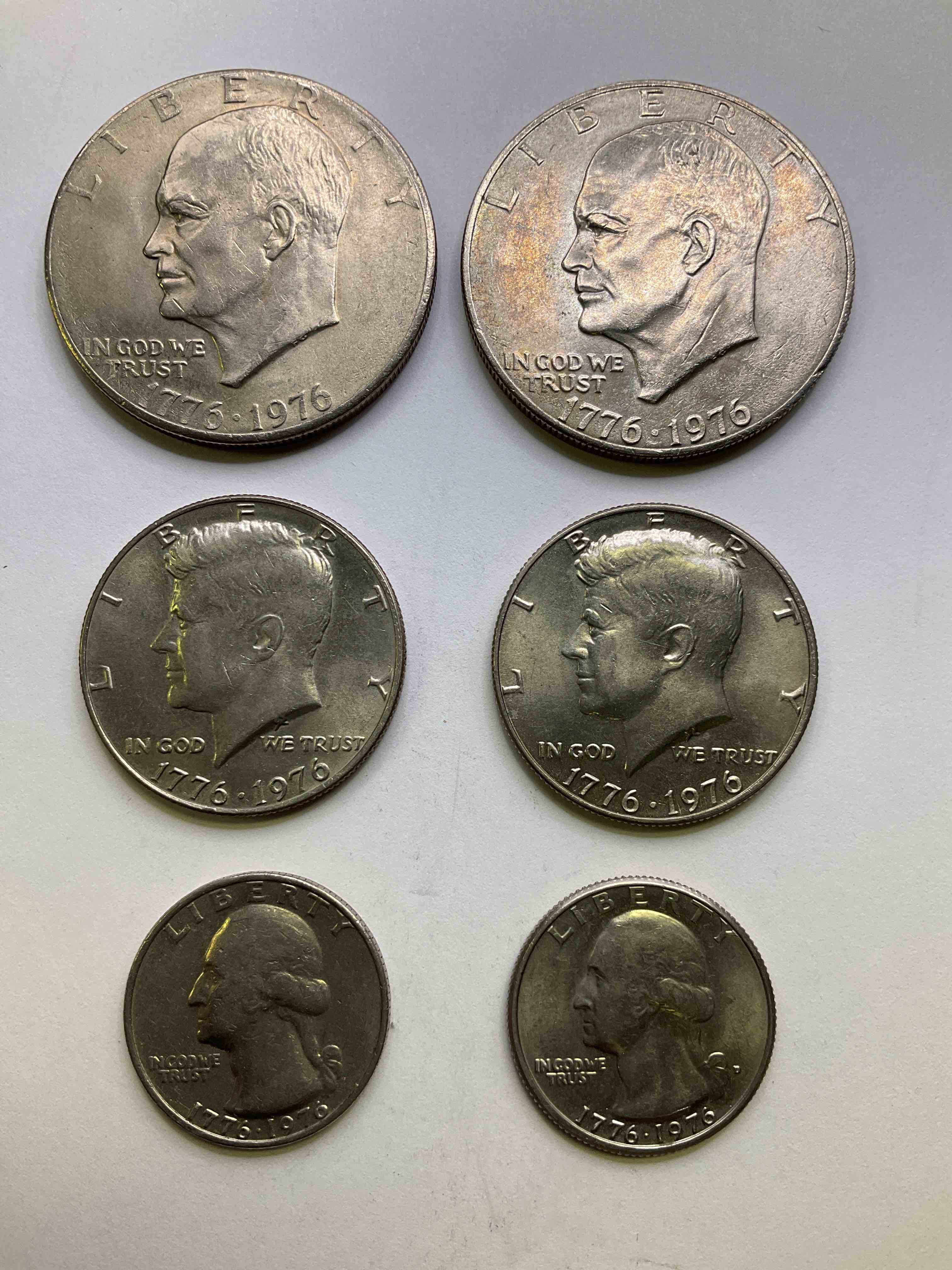 1976 Bicentennial Bliss! In 1976 The U.S. Mint Produced Coins Celebrating The 200 Year Anniversary Of America. Up For Auction Are Awesome Examples Of All Three Coins Produced For This... The Quarter, Half Dollar & Dollar Coin! Dollar Coins Show Great Toning, Highly Desirable For Collectors! Own Pieces Of History & Get Ready For America's 250 Year Anniversary Coming Soon!