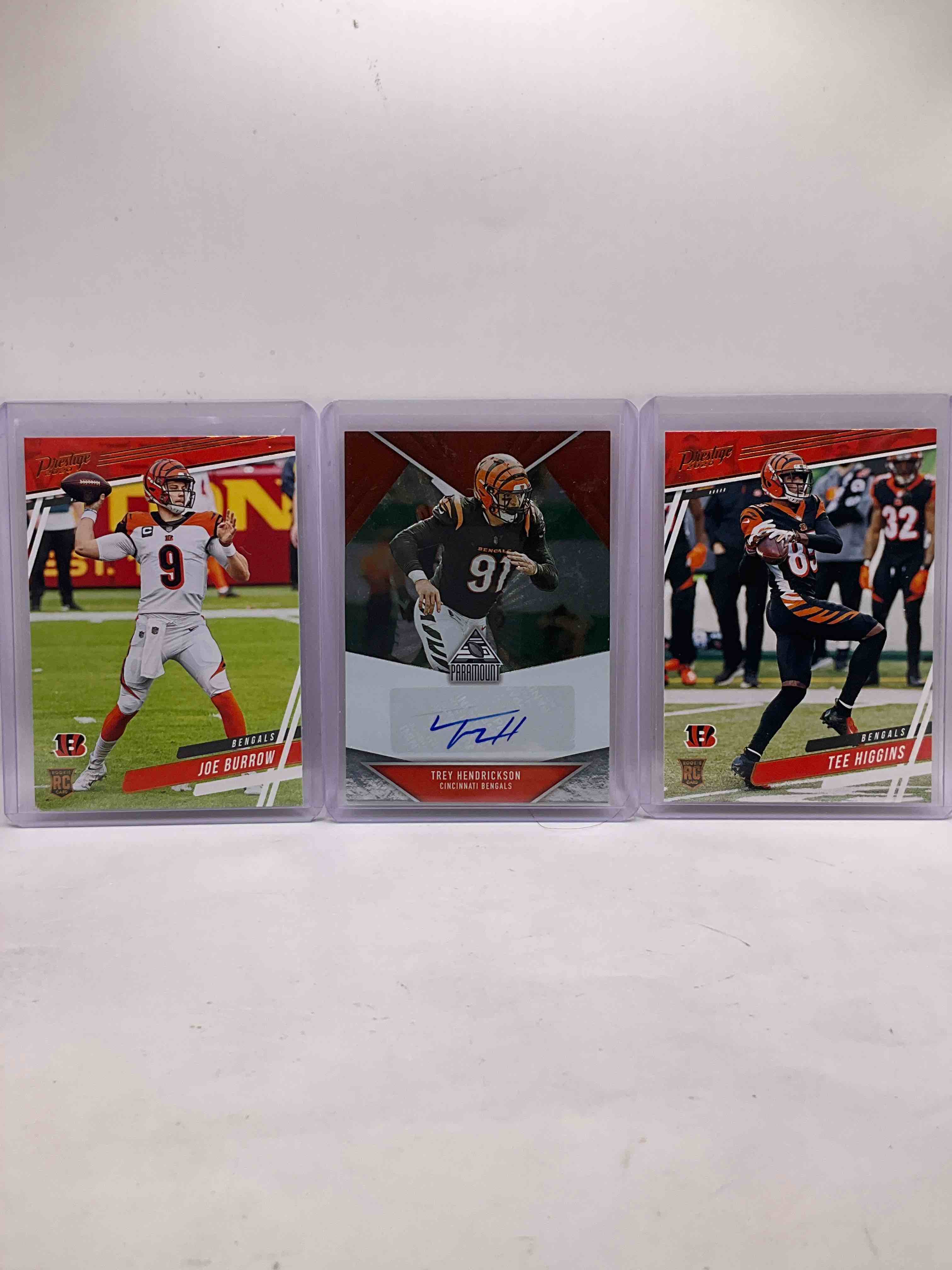 Bengals 50 Card Craziness! Trey Hendrickson Signature Paramount Card, Joe Burrow & Tee Higgins GOLD Prestige Rookie Card, Ja’marr Chase Rookies, Burrow Illusions Rookie, Along With Many Other Insane Bengals Cards!