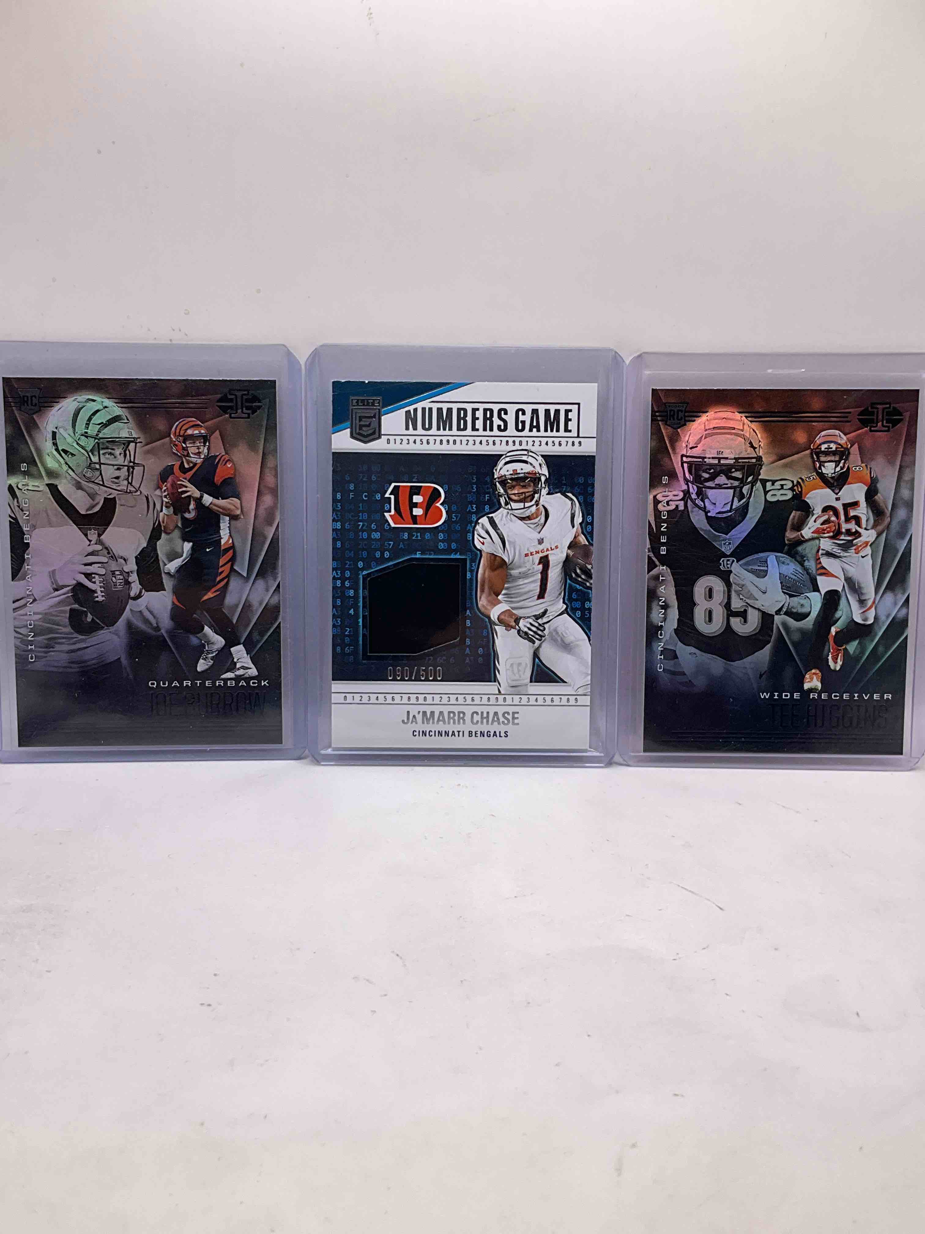 Bengals Bonanza! Joe Burrow & Tee Higgins Matching Illusions Bundle, Ja’marr Chase Elite Jersey Card /500, Joe Burrow Illusions /299, Cris Collinsworth Rookie, Optics, Mosaics, Hendrickson & More!