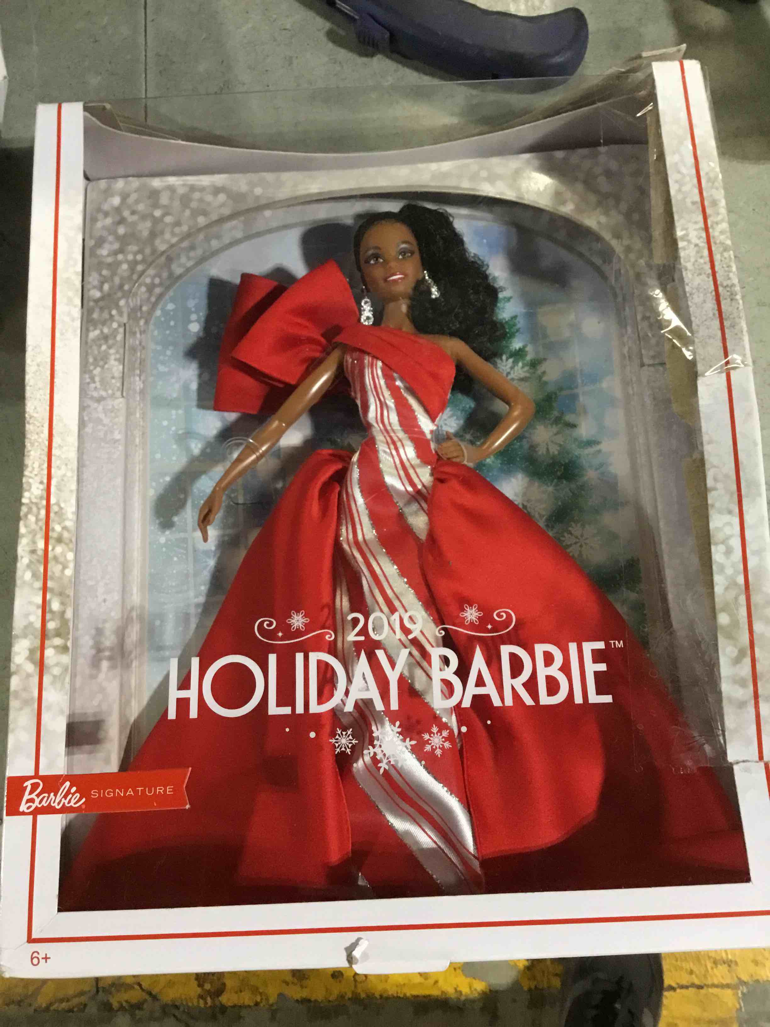 Condition photo showing New/Like New for Barbie 2019 Holiday Doll, 11.5-inch, Brunette, Wearing Red and White Gown, with Doll Stand and Certificate of Authenticity