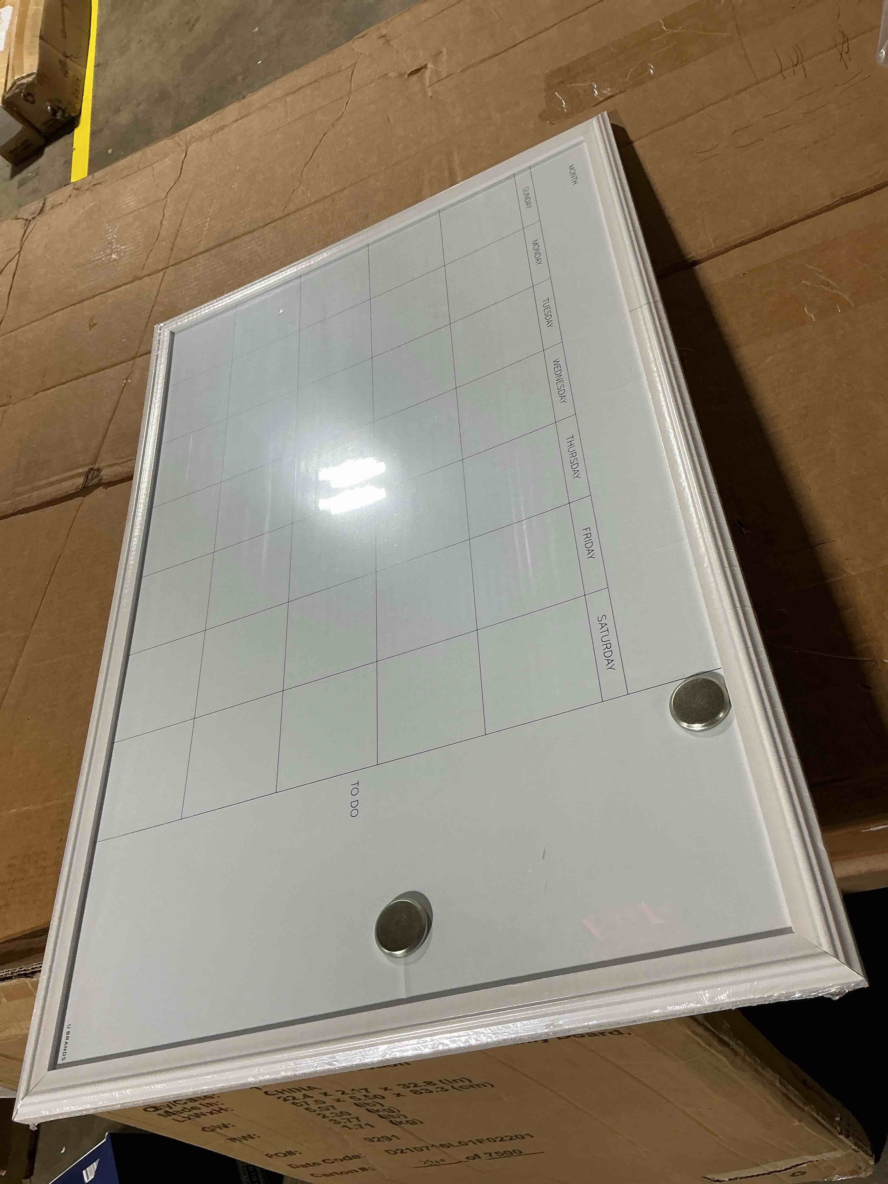 Condition photo showing As Is for u brands magnetic dry erase calendar white board, 30" x 20", white wood style frame, includes magnets 30"w x 20"h