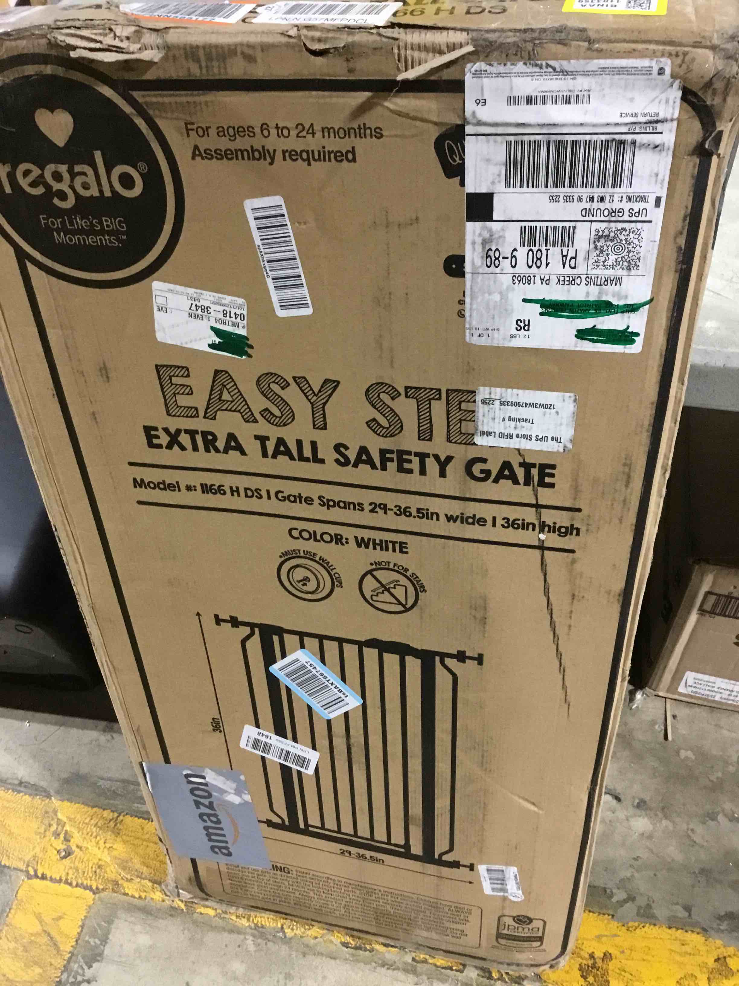Condition photo showing As Is for Regalo Easy Step Extra Tall Walk Thru Baby Gate, Includes 4-Inch Extension, and 4 Pack of Wall Cups and Mounting Kit, White White 29-36.5"W x 36"H