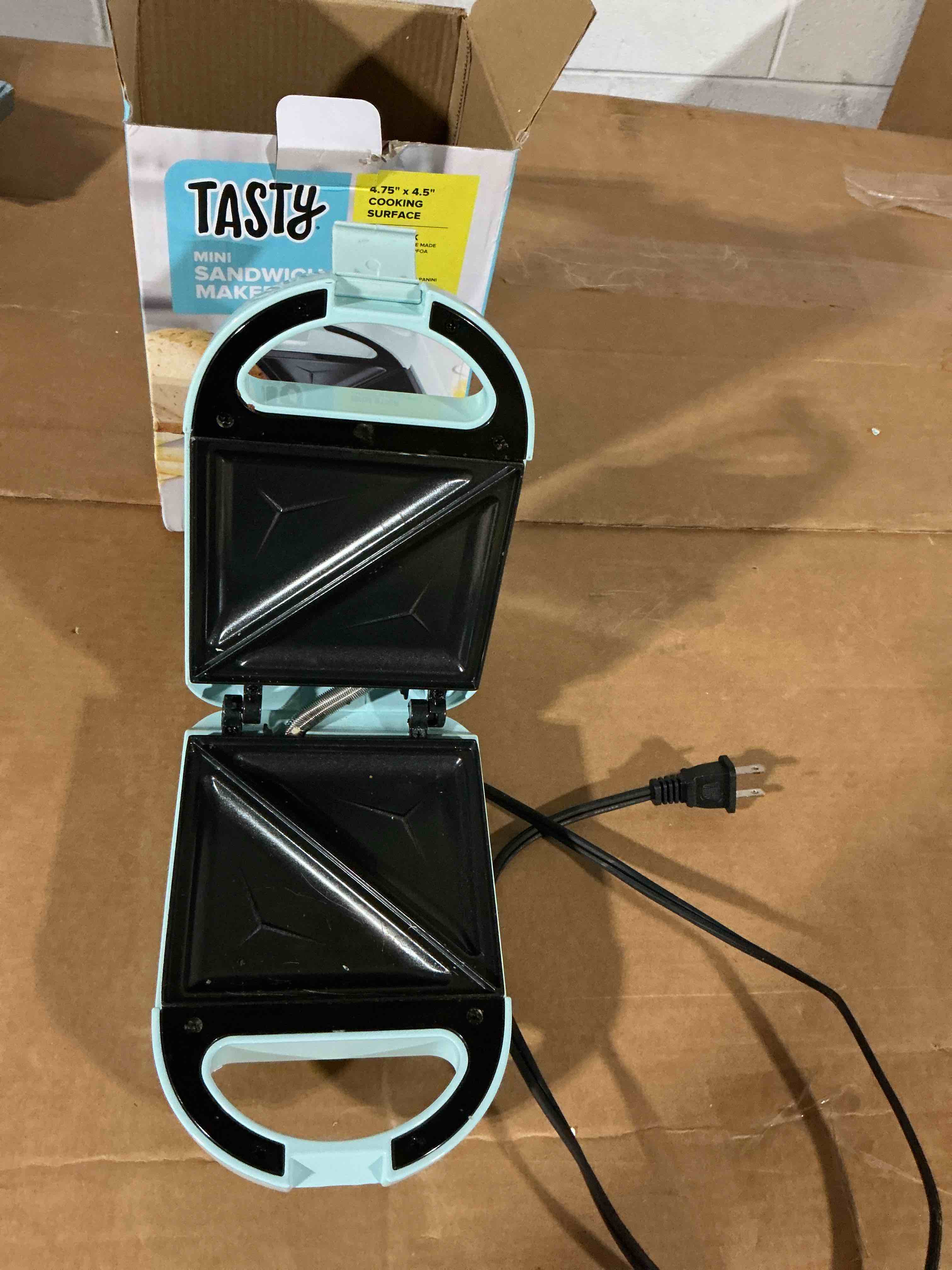 Condition photo showing As Is for tasty mini sandwich maker, makes sandwiches, paninis, grilled cheese, desserts, quick results, easy cleanup, 600w, aqua mini aqua