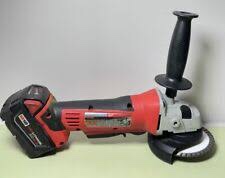 Milwaukee M18 cordless angle grinder.  It is a power tool used for grinding, cutting, and sanding various materials. It operates on an 18V battery system. It features a brushless motor for enhanced power and efficiency. It has a variable speed setting for greater control. It includes a tool-free guard adjustment for convenience. Some models have a rapid stop brake for added safety. It is compatible with 4-1/2" or 5" grinding discs. It is designed for both professional and DIY use.
