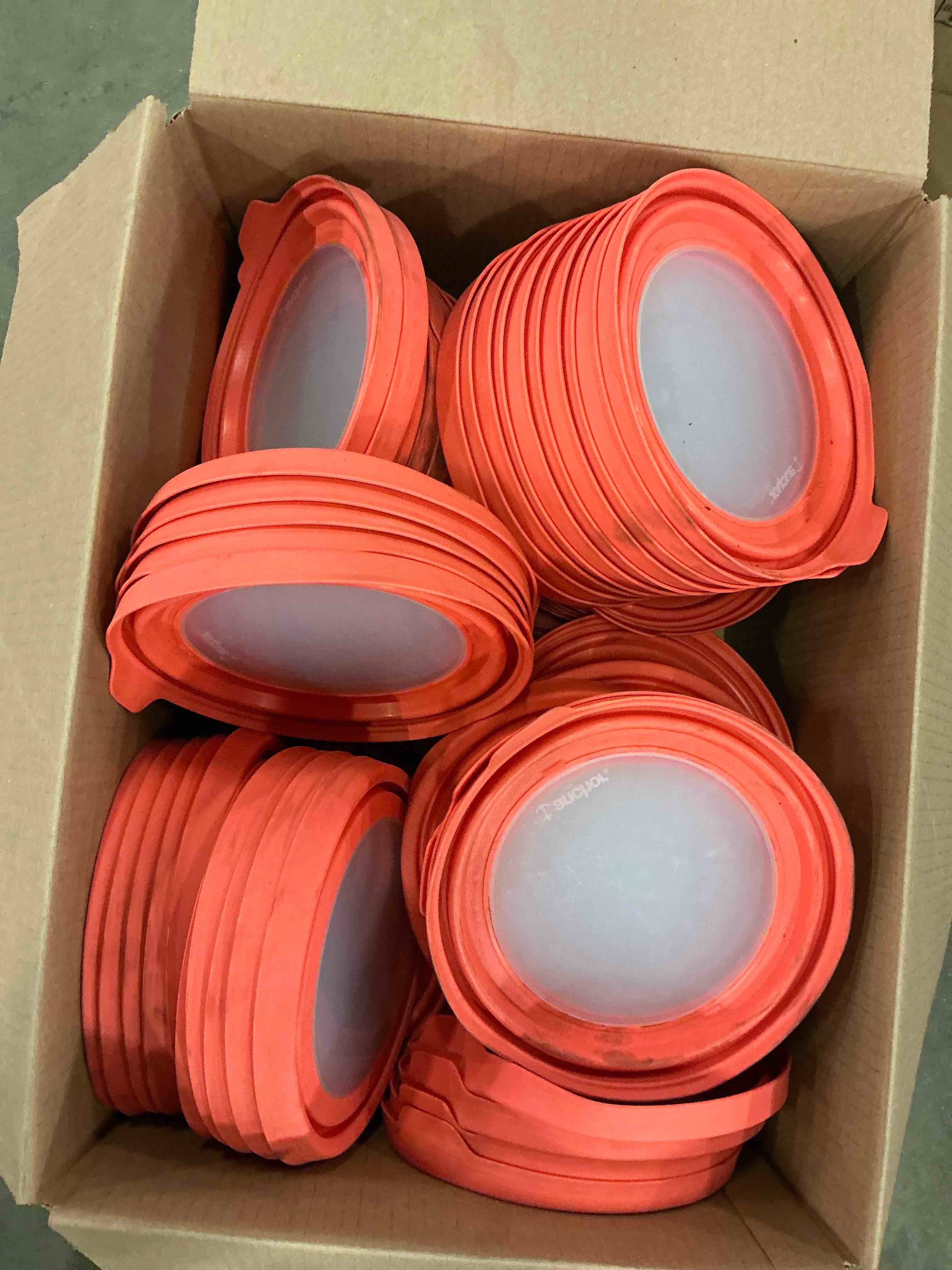 Assortment of orange silicone lids
